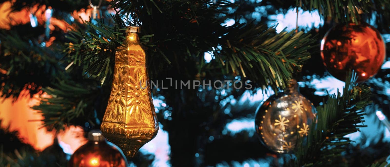 Decorated Christmas tree closeup. Widescreen image of an artificial Christmas tree with decorations