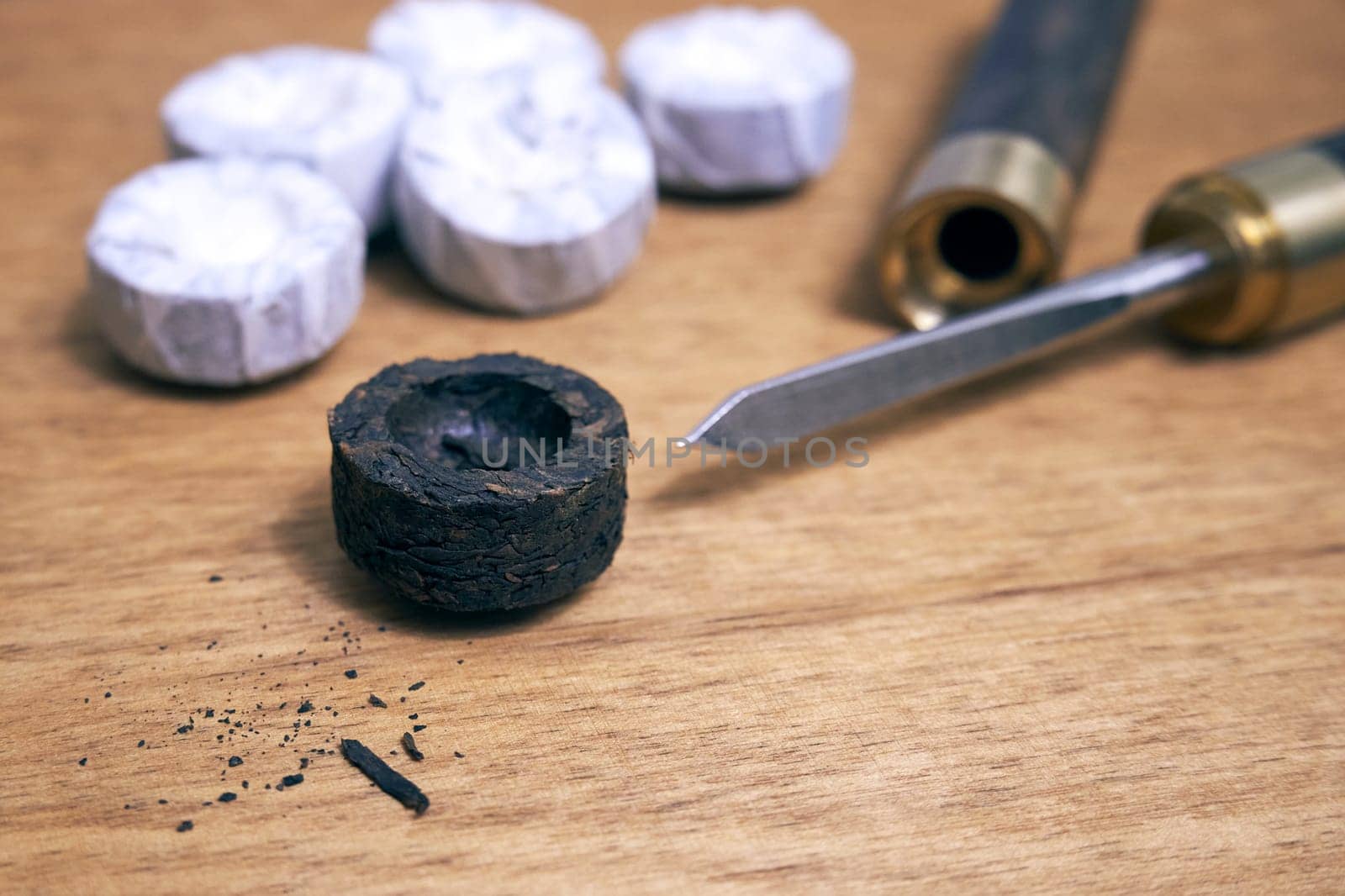 Pu-erh tea and a special knife for grinding on a wooden table