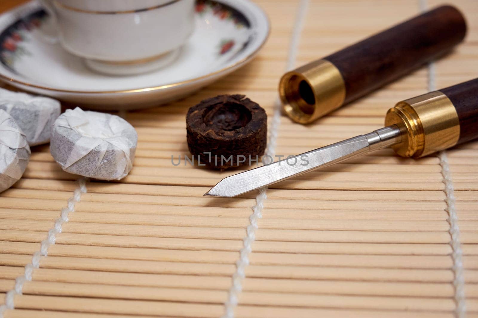 Pu-erh tea knife on a bamboo mat. Tea ceremony