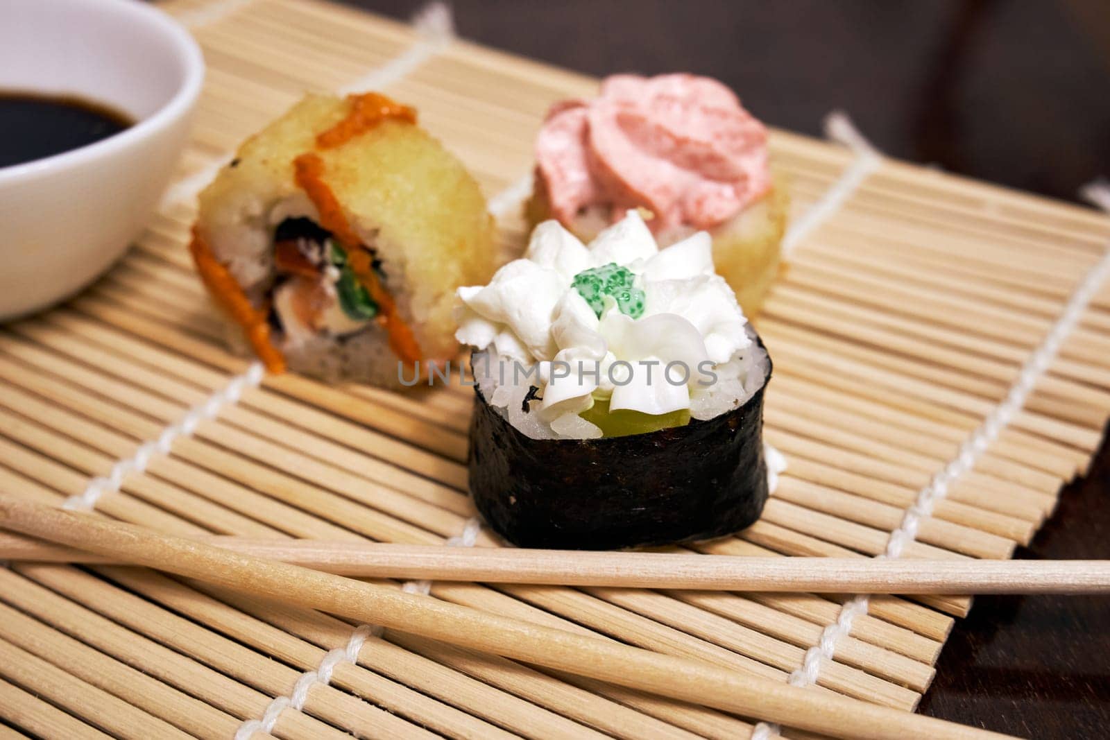 Sushi rolls on a bamboo mat close-up. Traditional Japanese food. Selective Focus