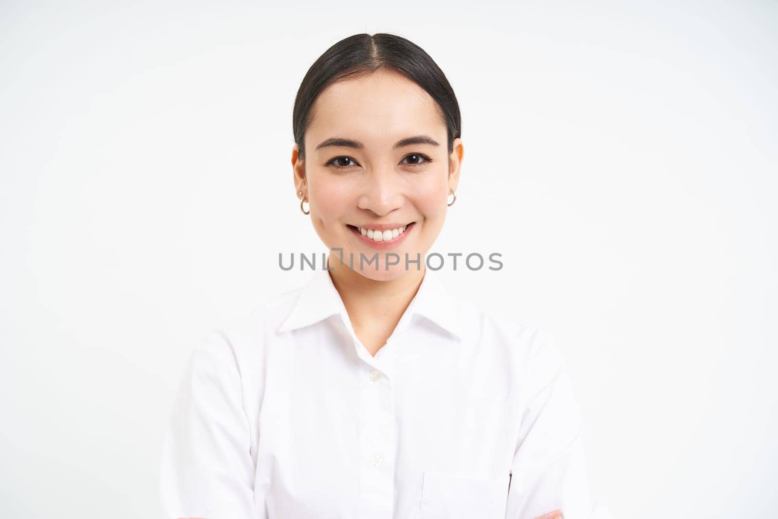 Portrait of young asian woman professional, smiling with confidence, professional look, standing over white background.