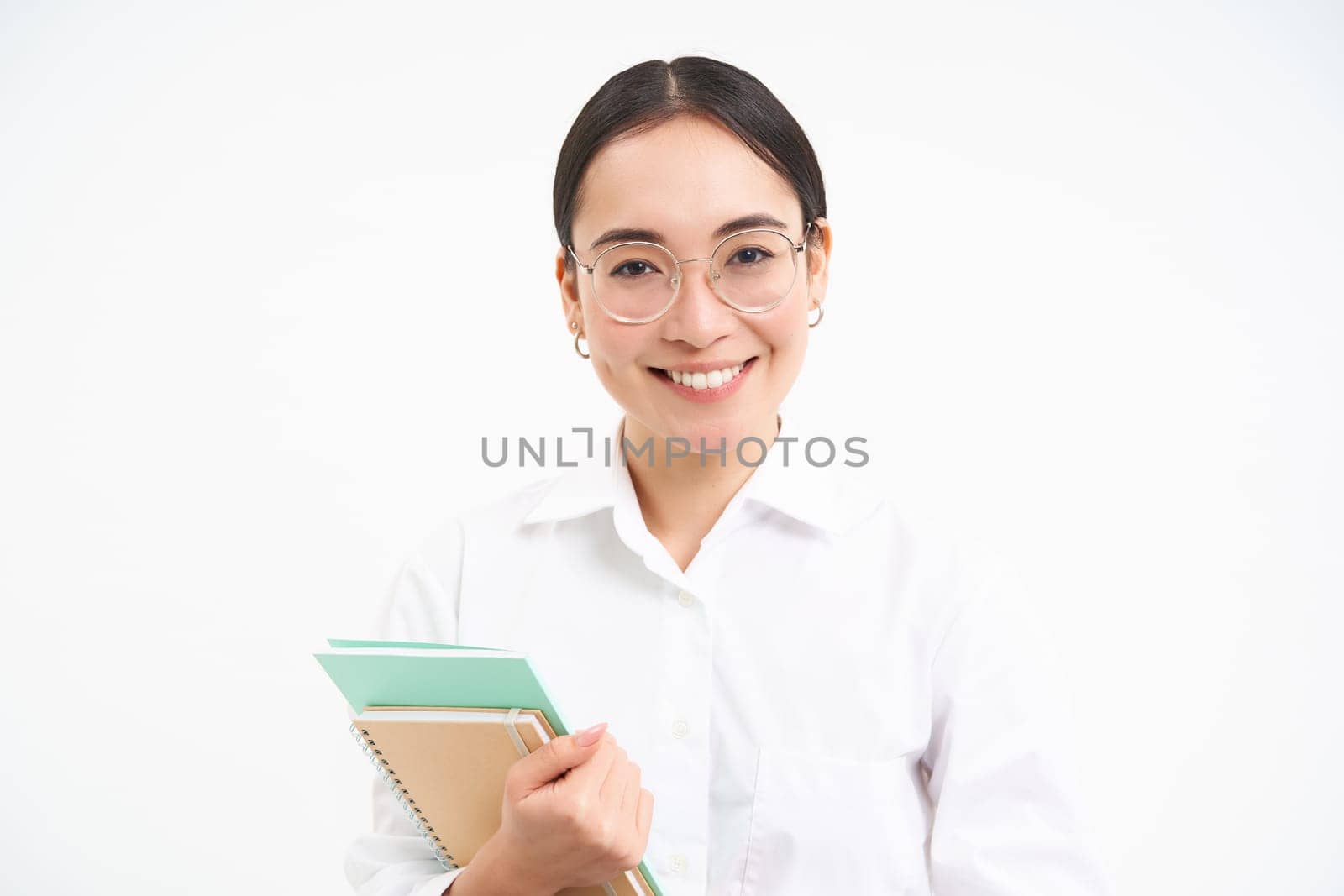 Asian woman, teacher with notebooks, smiling and looking confident, isolated on white background.