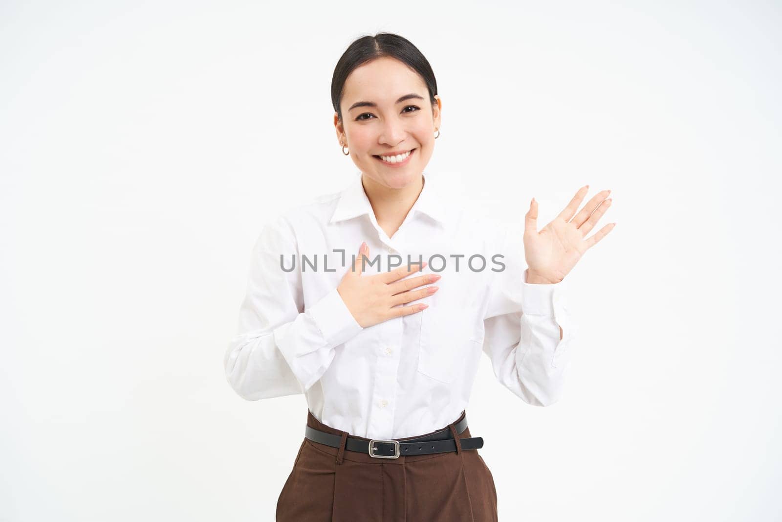 Friendly smiling businesswoman, introduces herself, says her name, stands over white background by Benzoix