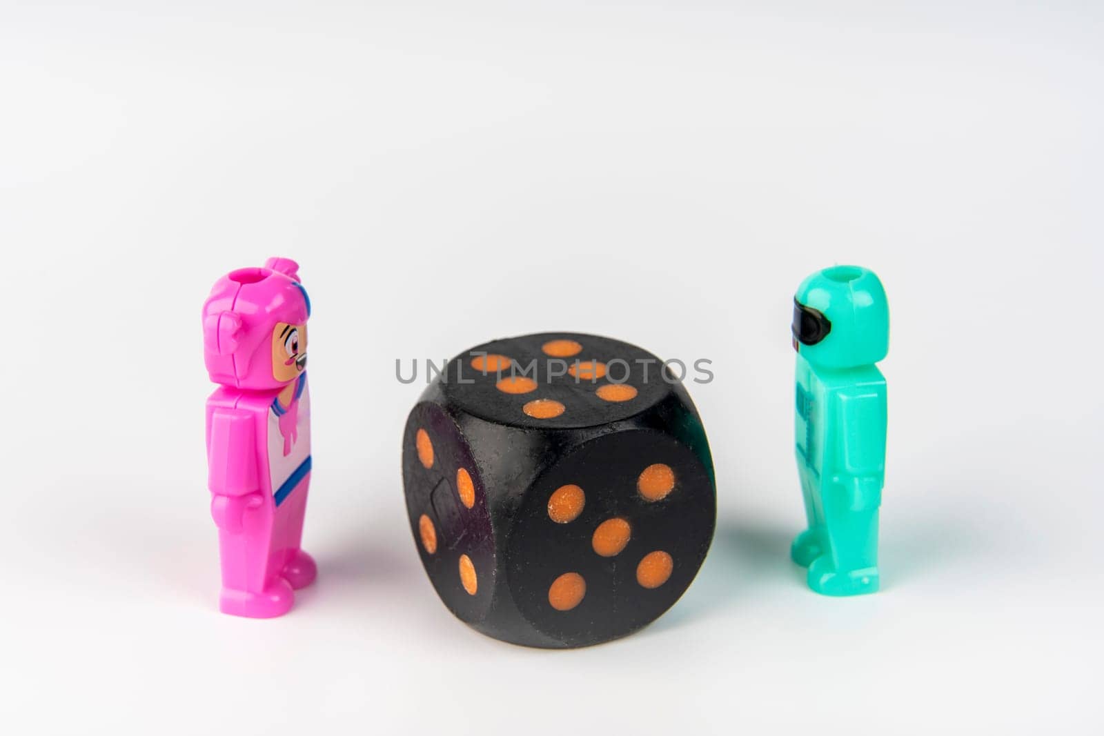 a playing cube showing six. The concept of a game, a chance, a win. Toy Figures roll dice. High quality photo
