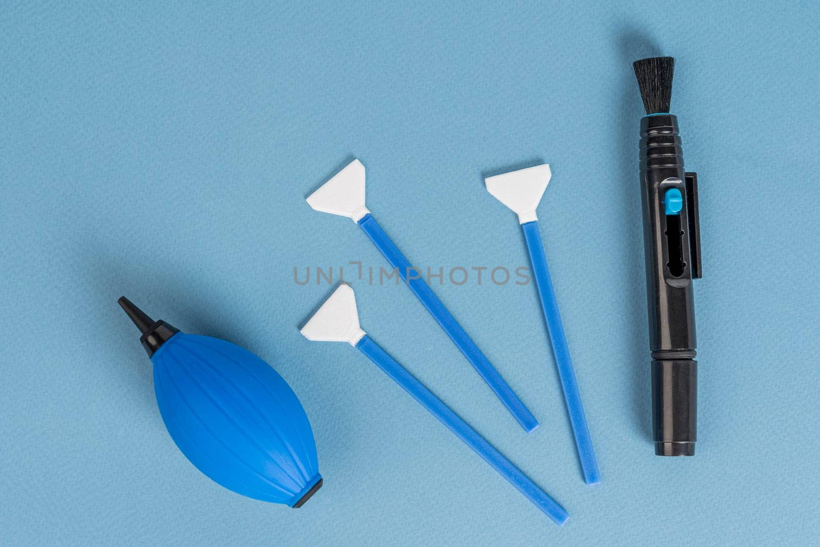 a set for cleaning the chamber from dirt. a purge bag, a mop for cleaning the matrix, a cleaning liquid. blue background