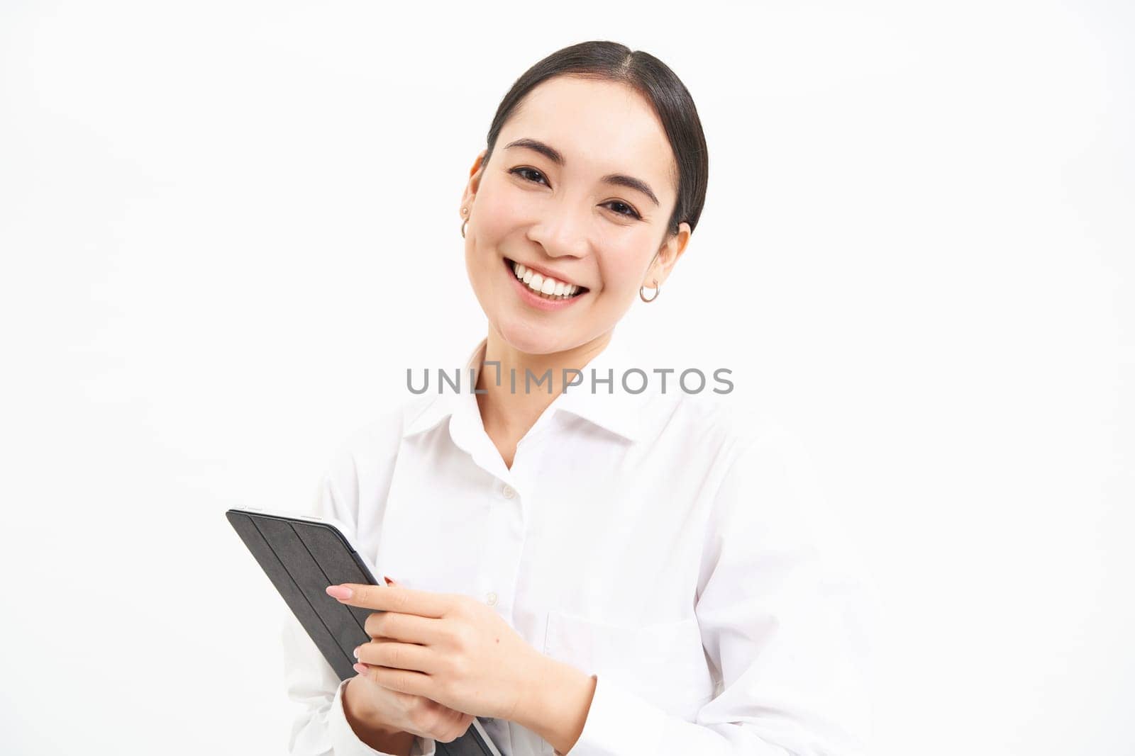 Corporate asian woman, manager using digital tablet, working on gadget, checking charts, company statistics, standing over white background.