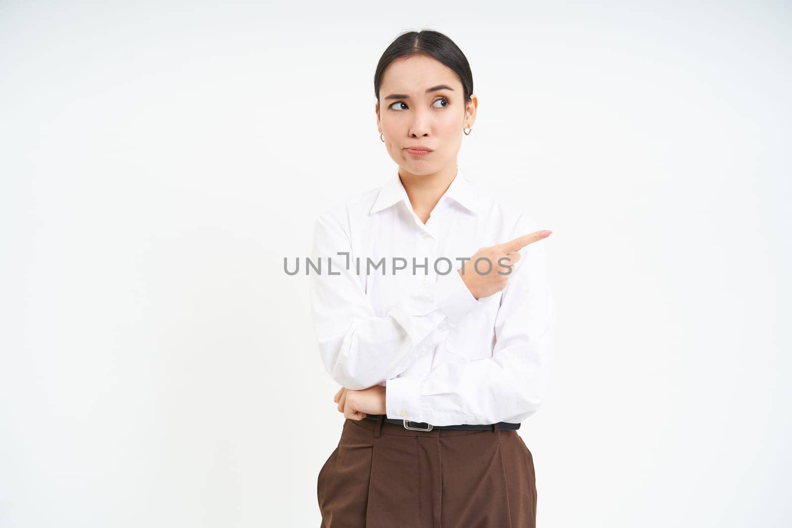 Image of female employee, office worker points finger at banner, shows promo advertisement on isolated white background by Benzoix