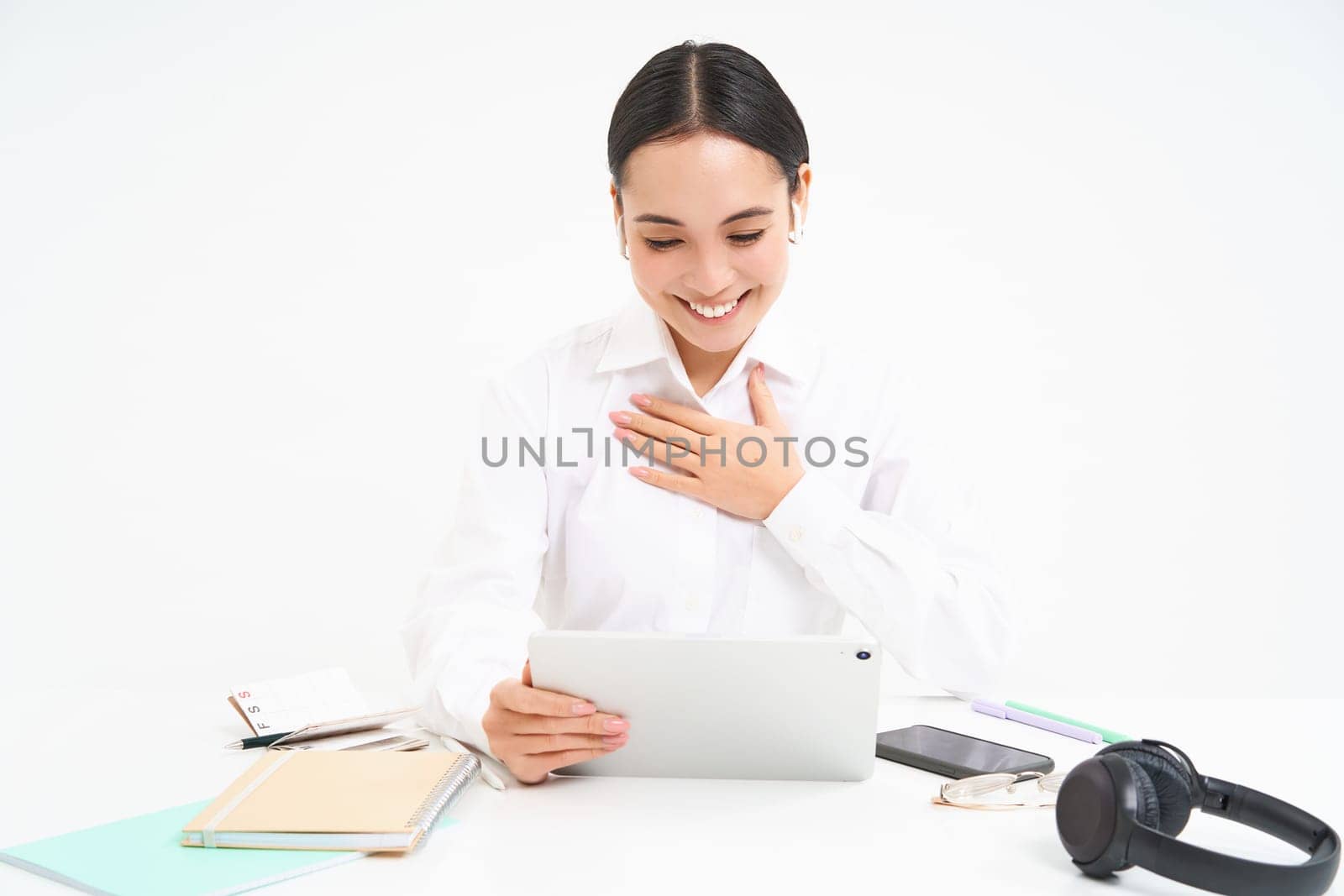 Image of saleswoman, asian entrepreneur talks on video chat from her office, has a meeting, connects to webinar online, white background by Benzoix