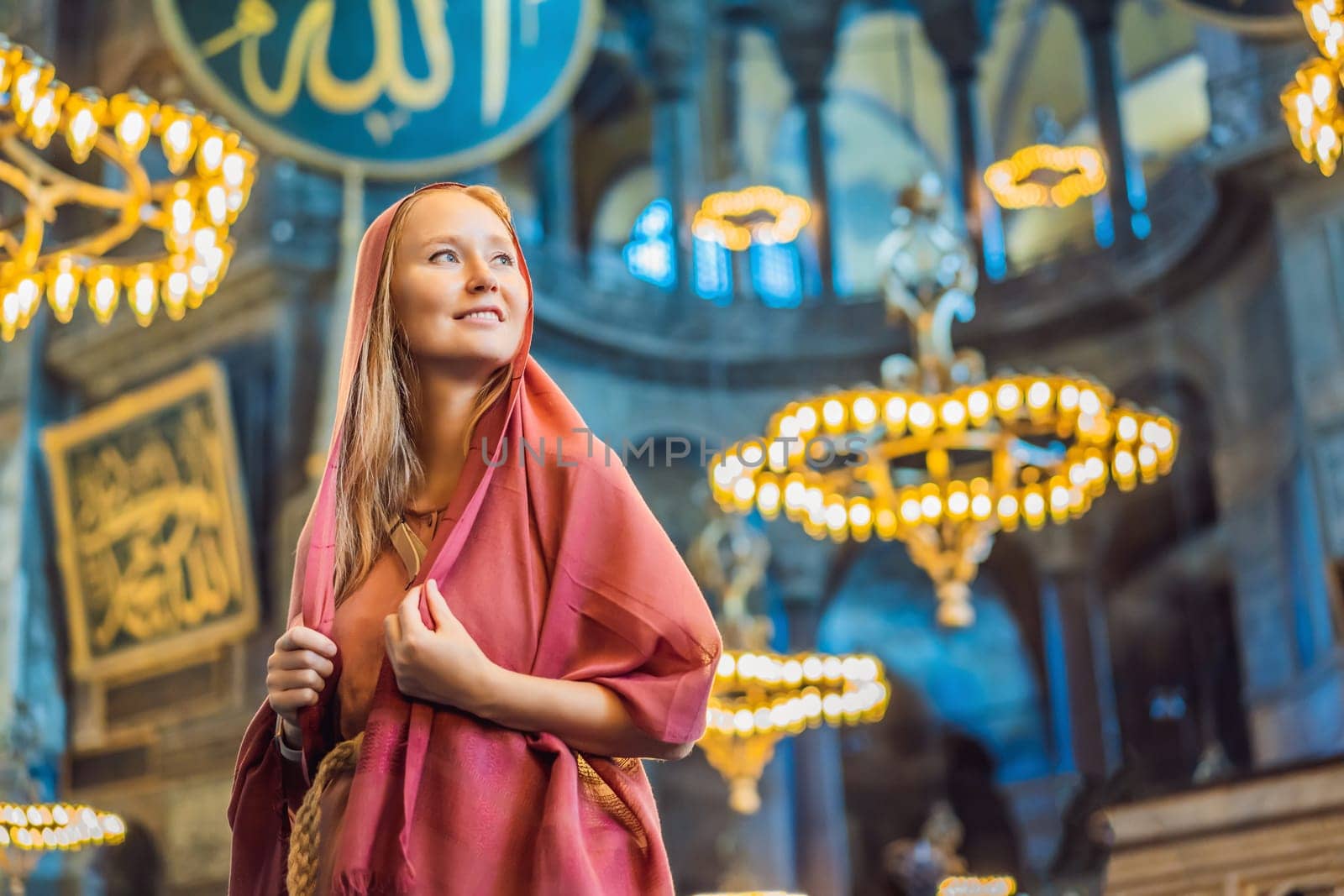 Woman tourist enjoying Hagia Sofia, Ayasofya interior in Istanbul, Turkey, Byzantine architecture, city landmark and architectural world wonder. Turkiye.