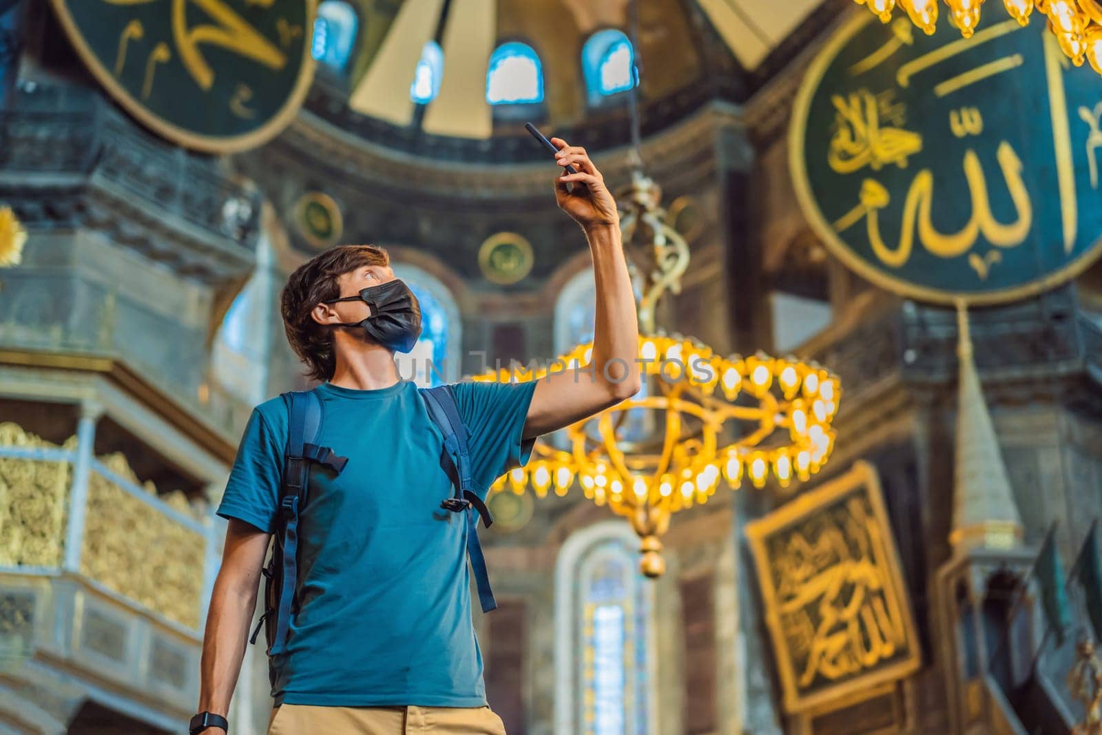 Man tourist enjoying Hagia Sofia, Ayasofya interior in Istanbul, Turkey, Byzantine architecture, city landmark and architectural world wonder. Turkiye.