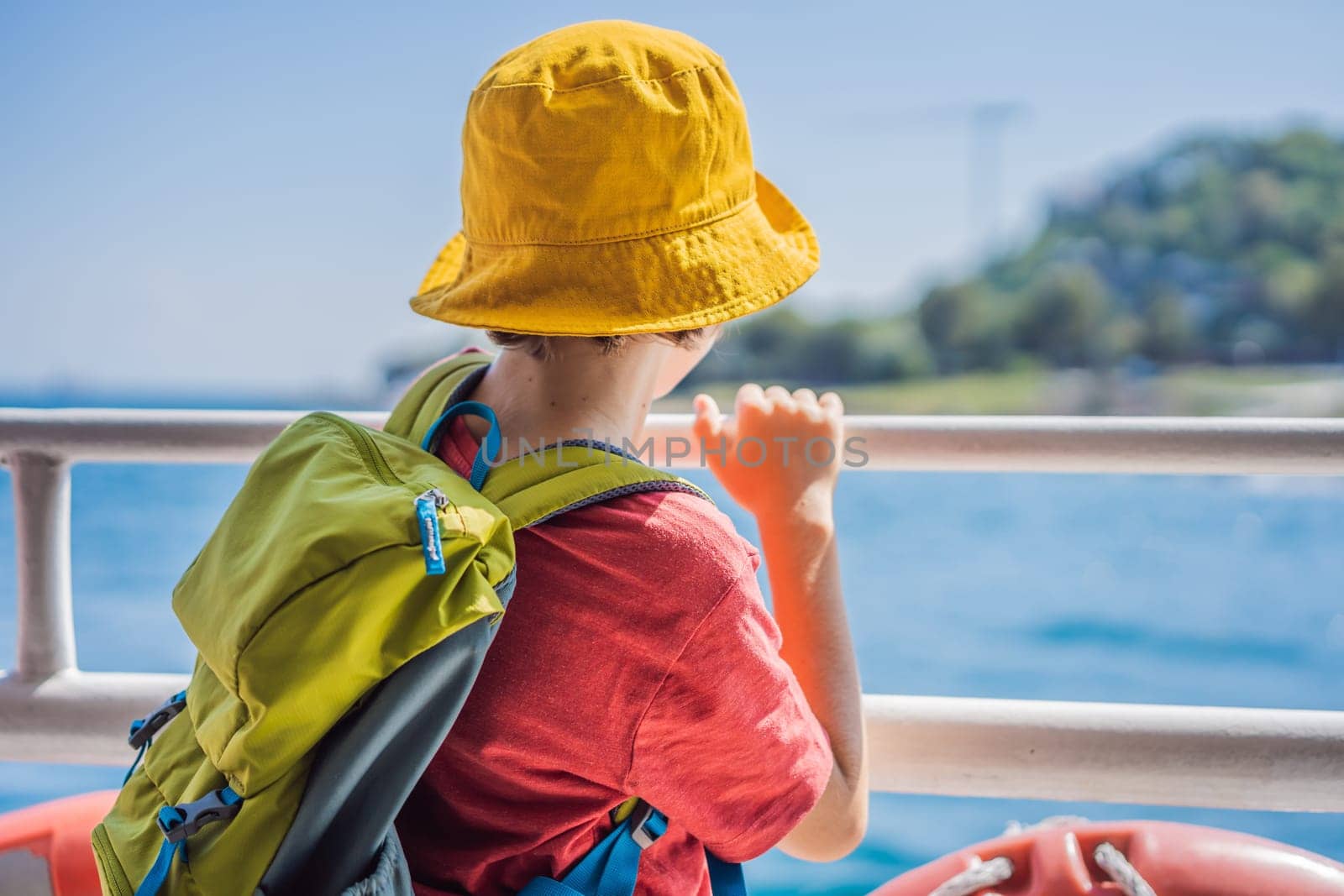 Happy boy enjoying the sea from ferry boat crossing Bosphorus in Istanbul. Summer trip to Istanbul. Traveling with kids concept.