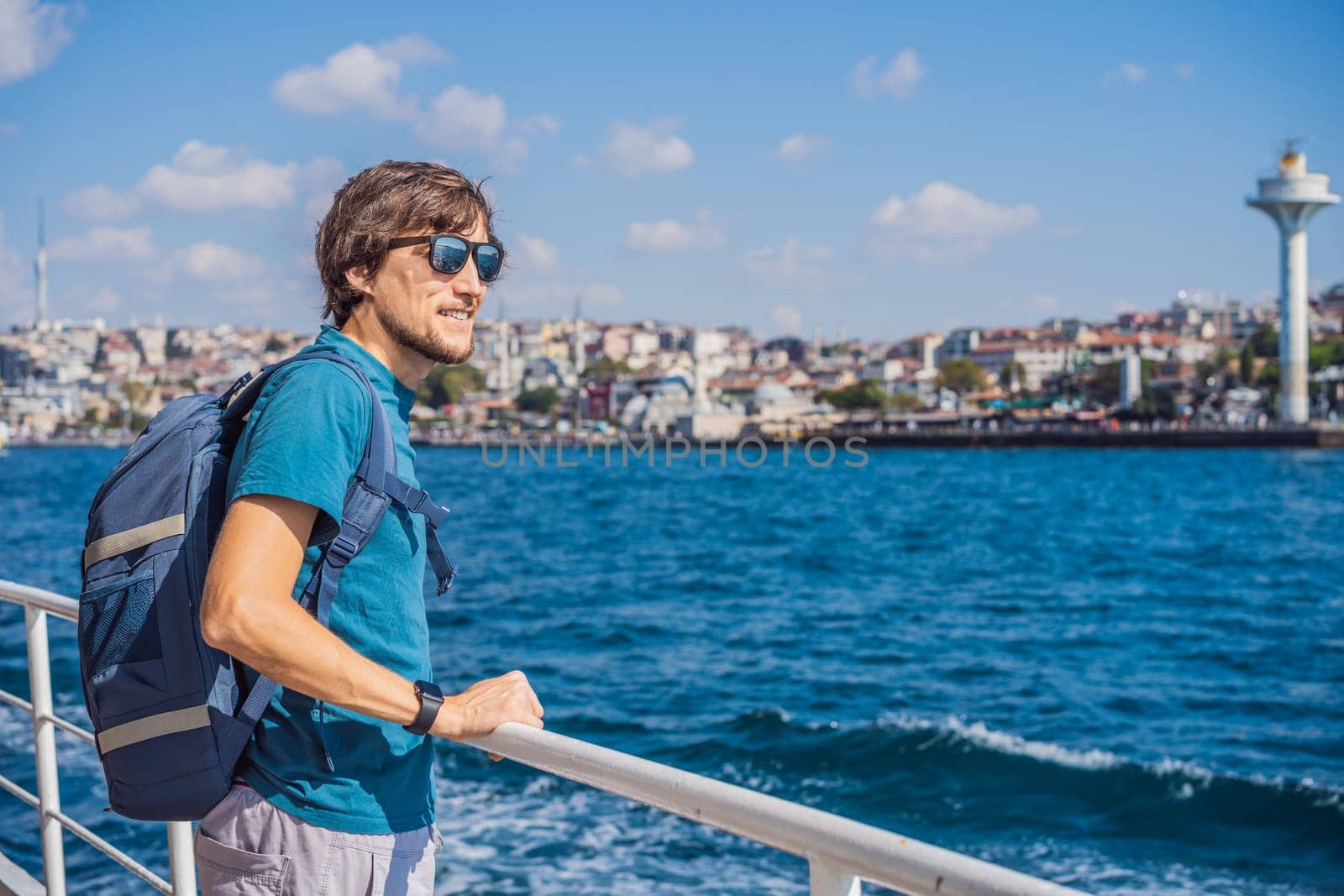 Happy man enjoying the sea from ferry boat crossing Bosphorus in Istanbul. Summer trip to Istanbul.