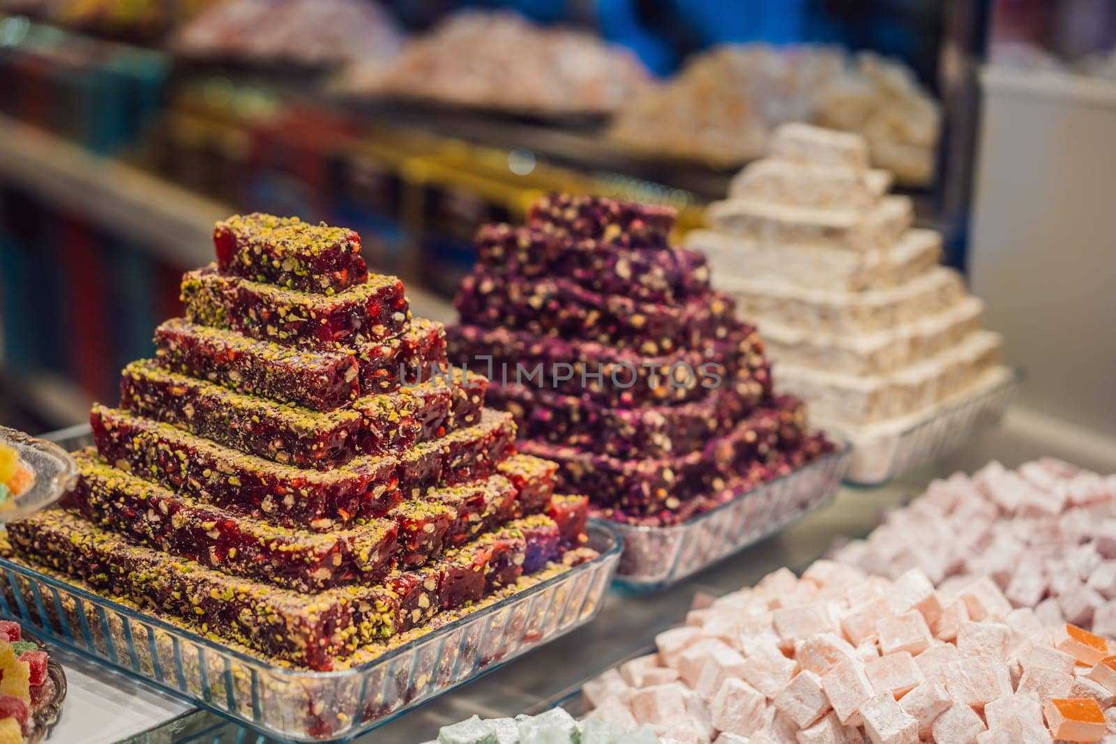 Traditional oriental sweet pastry cookies, nuts, dried fruits, pastilles, marmalade, Turkish desert with sugar, honey and pistachio, in display at a street food market.