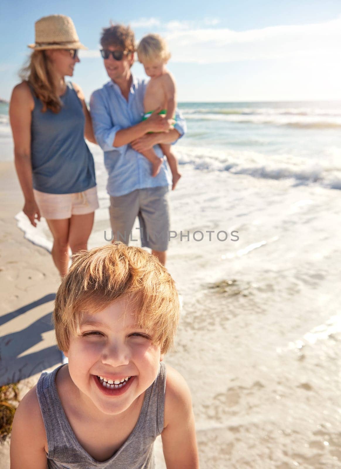 My whole family loves the beach. a young family enjoying a summer day out at the beach