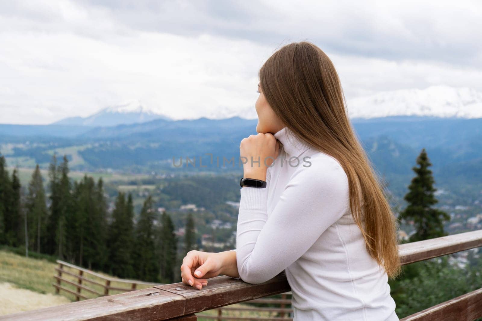 Young woman enjoying nature in Snowy Mountain in Polish Tatry mountains Zakopane Poland. Naturecore aesthetic beautiful green hills. Mental and physical wellbeing Travel outdoors tourist destination