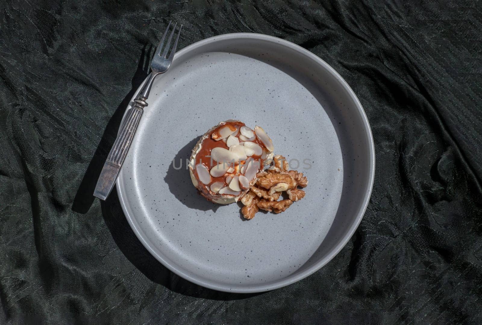 Thai milk tea Almond Minibon and Walnuts served with Metal fork on ceramic plate with dark background. Top view, Space for text, Selective focus.