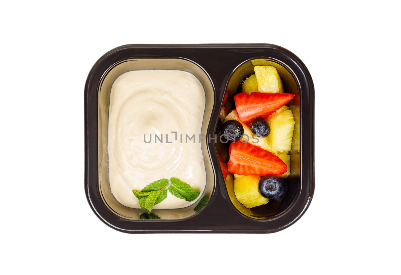 Dessert of applesauce, pineapple and strawberries in a plastic container on a white background. High quality photo
