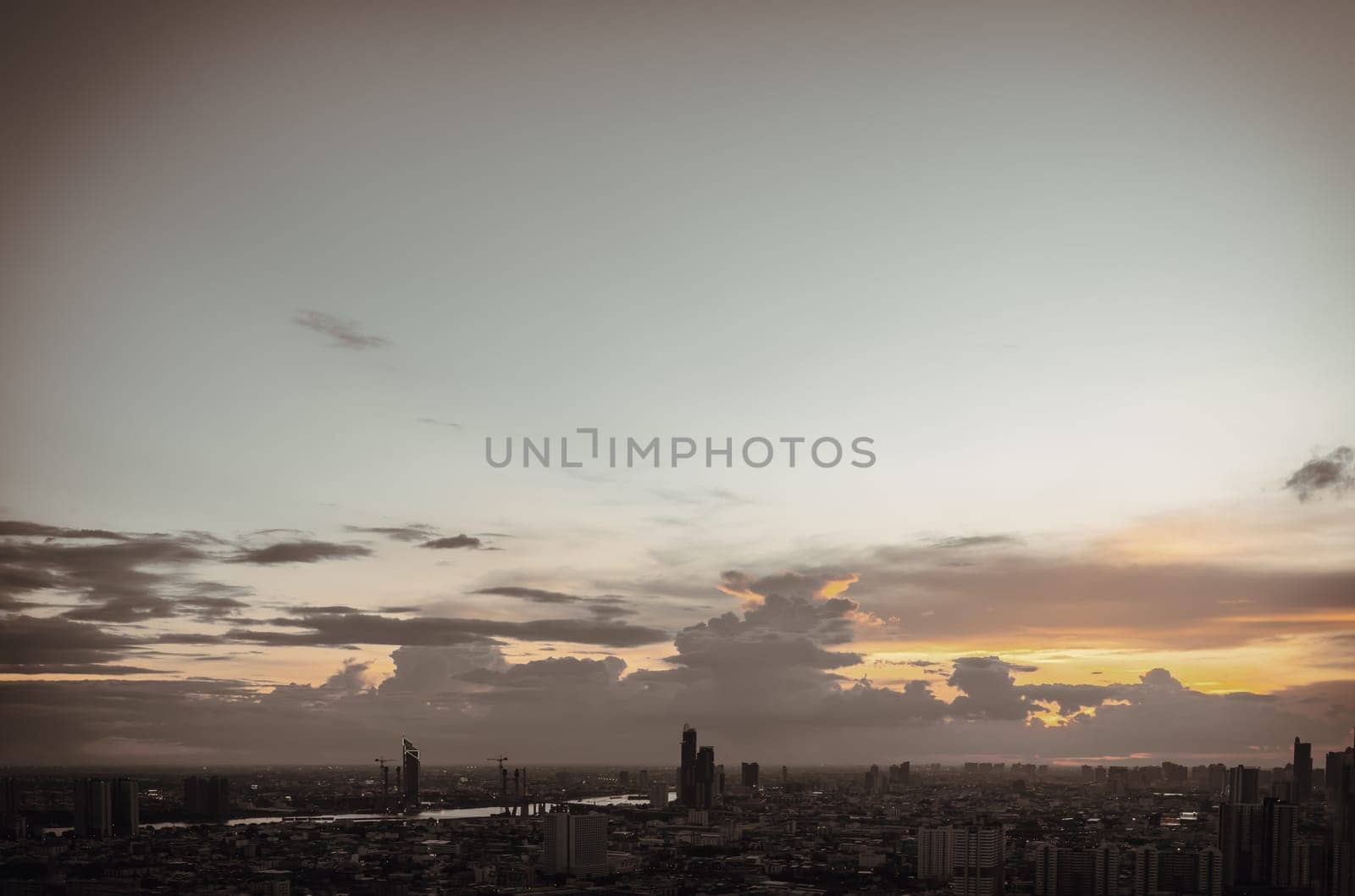 Bangkok, Thailand - Aug 14, 2022 - Gorgeous scenic of the sunset with cloud on the sky over large metropolitan city in Bangkok. Nice city view, Space for text, No focus, specifically.