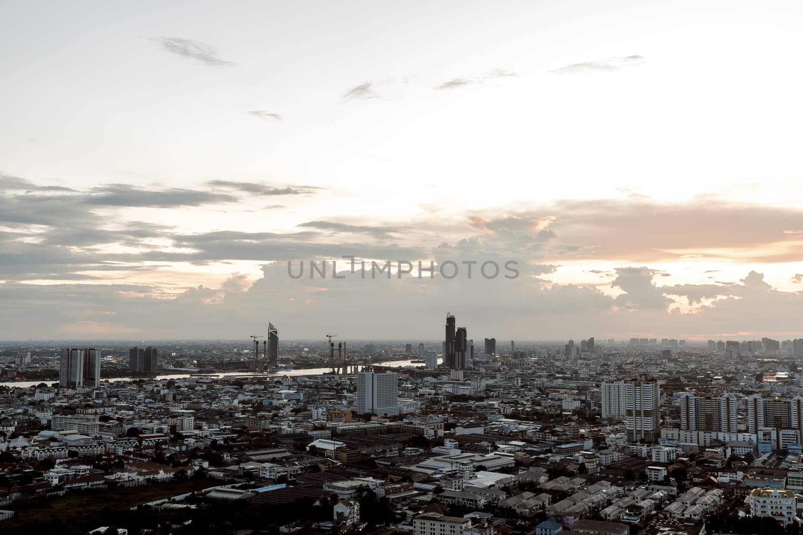 Bangkok, Thailand - Aug 14, 2022 - Gorgeous scenic of the sunset with cloud on the sky over large metropolitan city in Bangkok. Nice city view, Space for text, No focus, specifically.