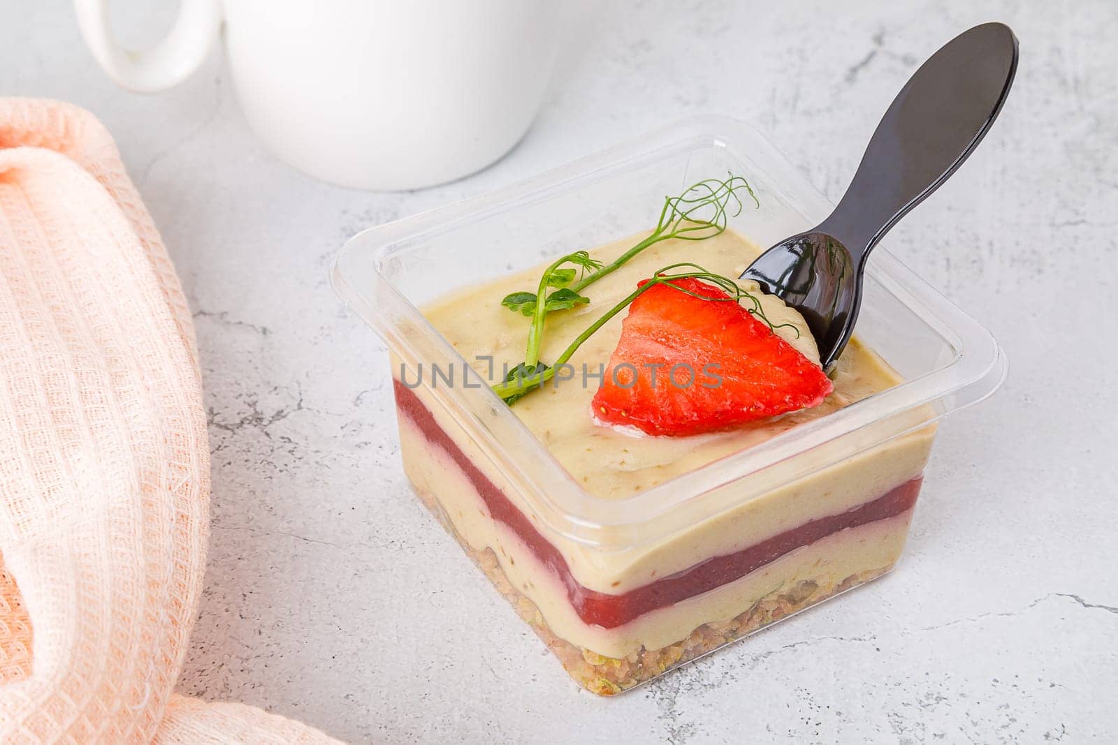 Sweet dessert of cream muesli jam and strawberries on a concrete background. High quality photo