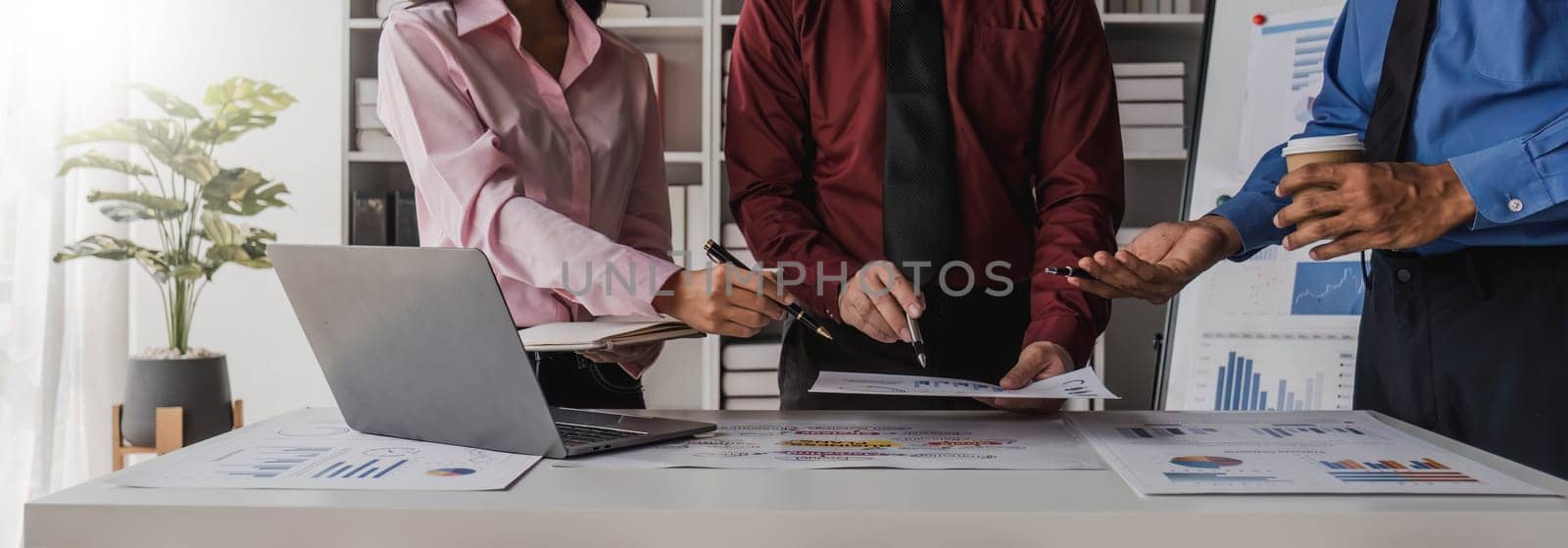 Business People Meeting using laptop computer,calculator,notebook,stock market chart paper for analysis Plans to improve quality next month. Conference Discussion Corporate Concept. by wichayada