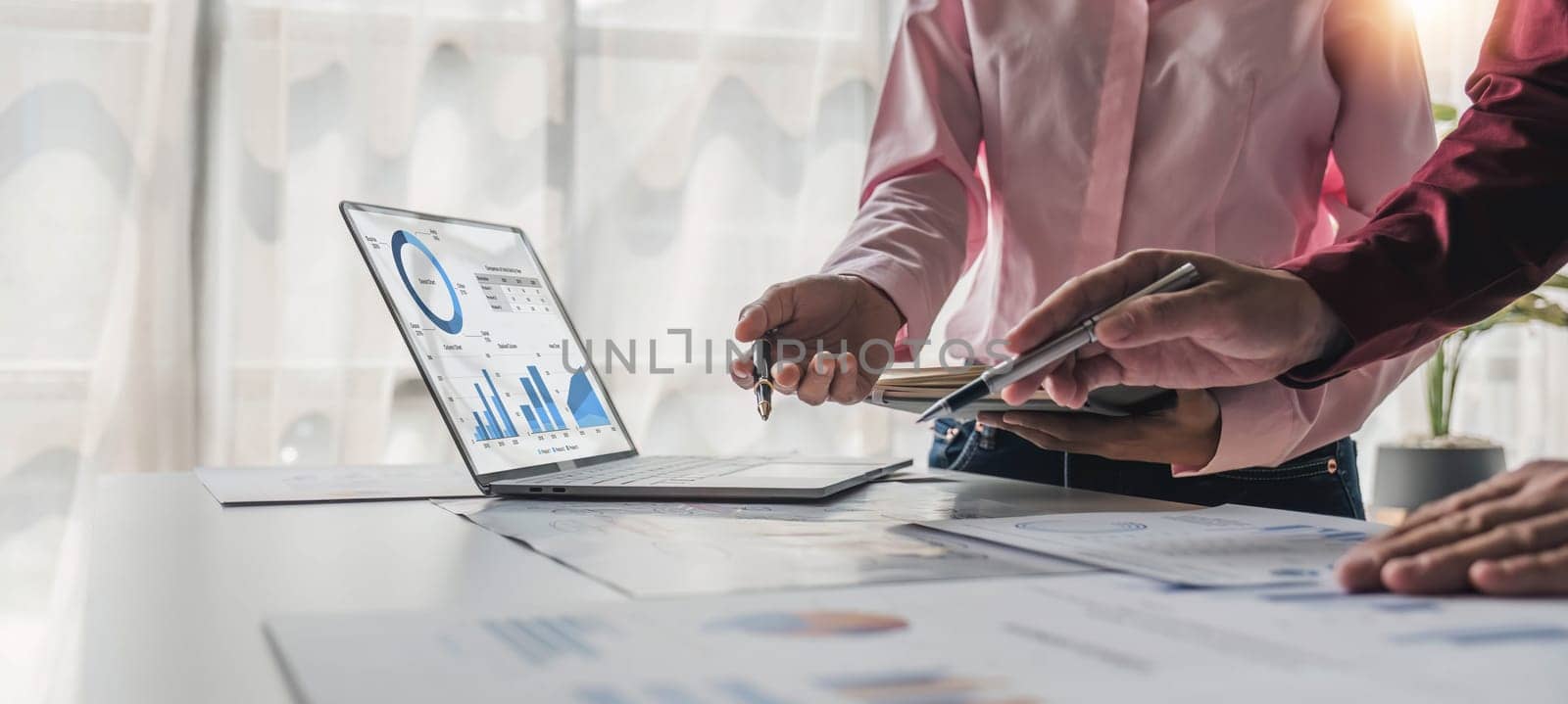 Business People Meeting using laptop computer,calculator,notebook,stock market chart paper for analysis Plans to improve quality next month. Conference Discussion Corporate Concept. by wichayada