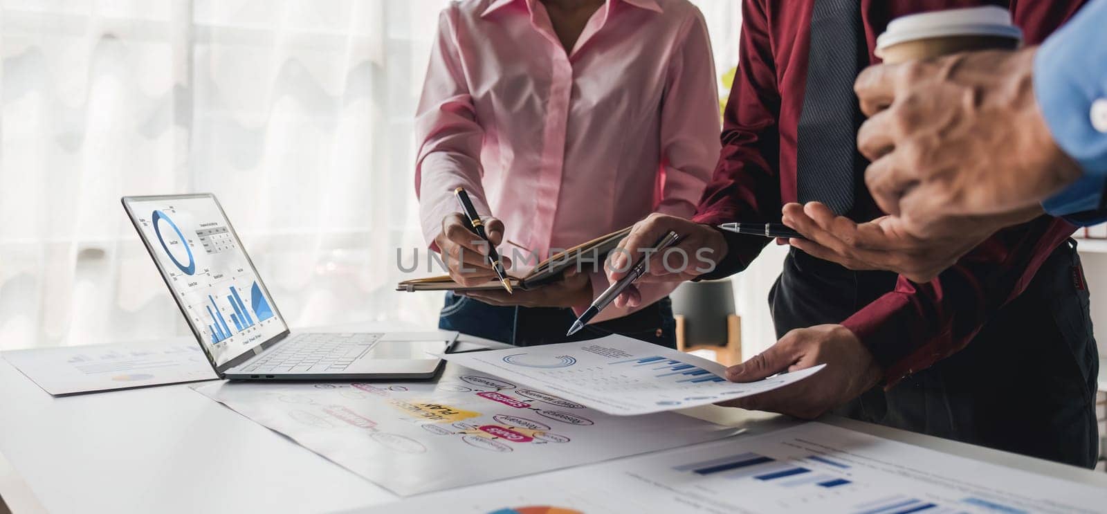 Business People Meeting using laptop computer,calculator,notebook,stock market chart paper for analysis Plans to improve quality next month. Conference Discussion Corporate Concept