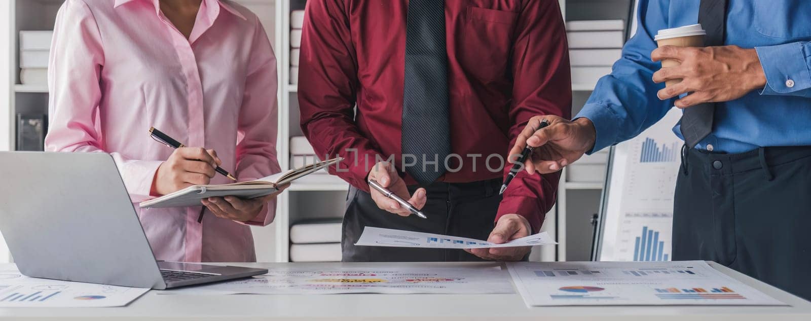 Business People Meeting using laptop computer,calculator,notebook,stock market chart paper for analysis Plans to improve quality next month. Conference Discussion Corporate Concept. by wichayada