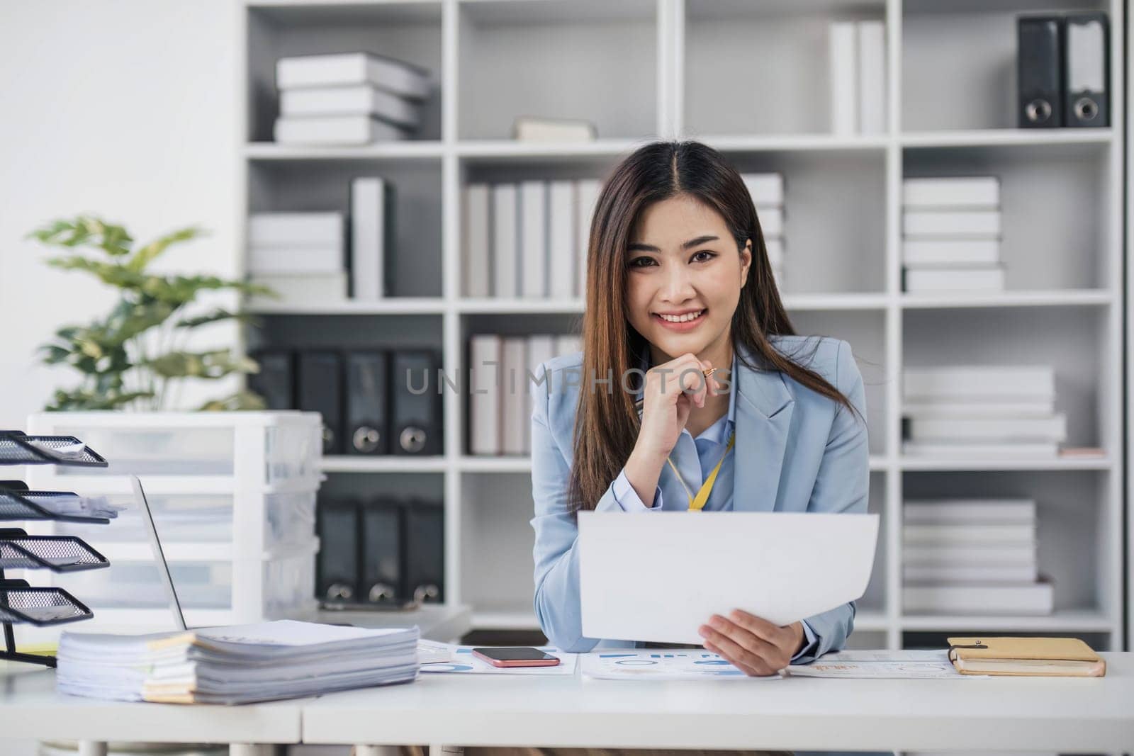 Smile Pretty business Asian woman is working her job on a laptop computer in a modern office. Doing accounting analysis report real estate investment data, Financial and tax systems concept...