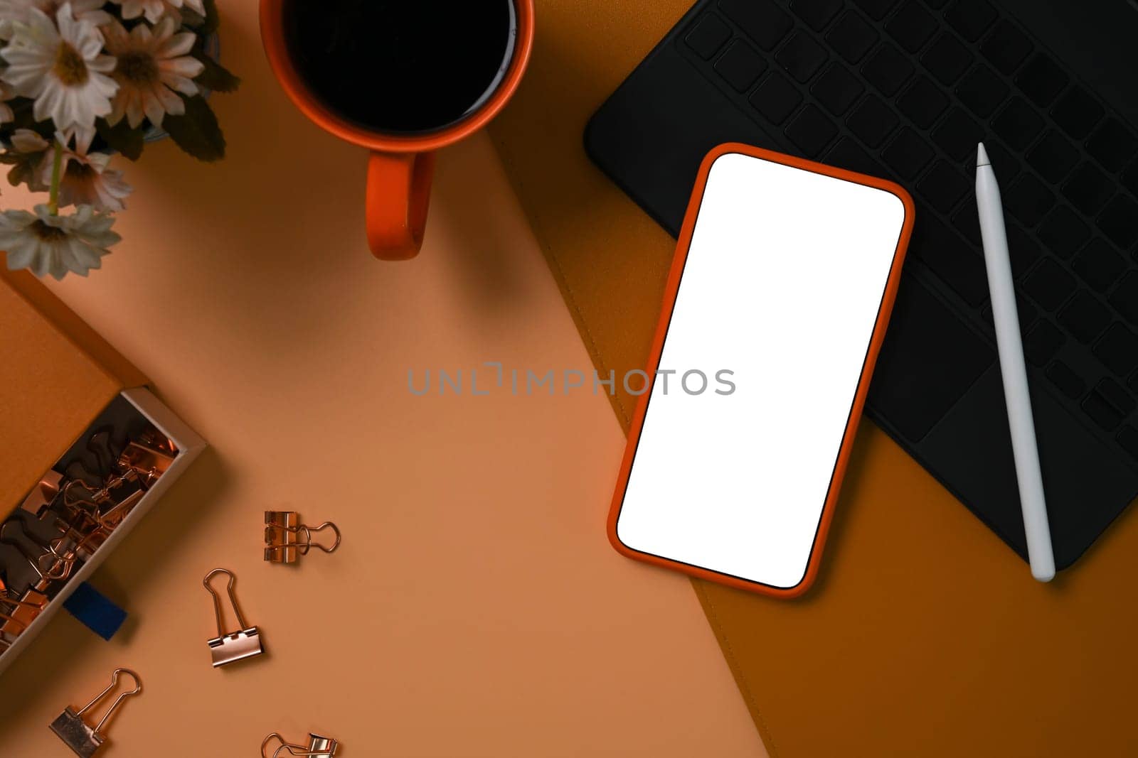 Mock up smart phone, coffee cup and book on brown leather. Blank screen for advertise text.