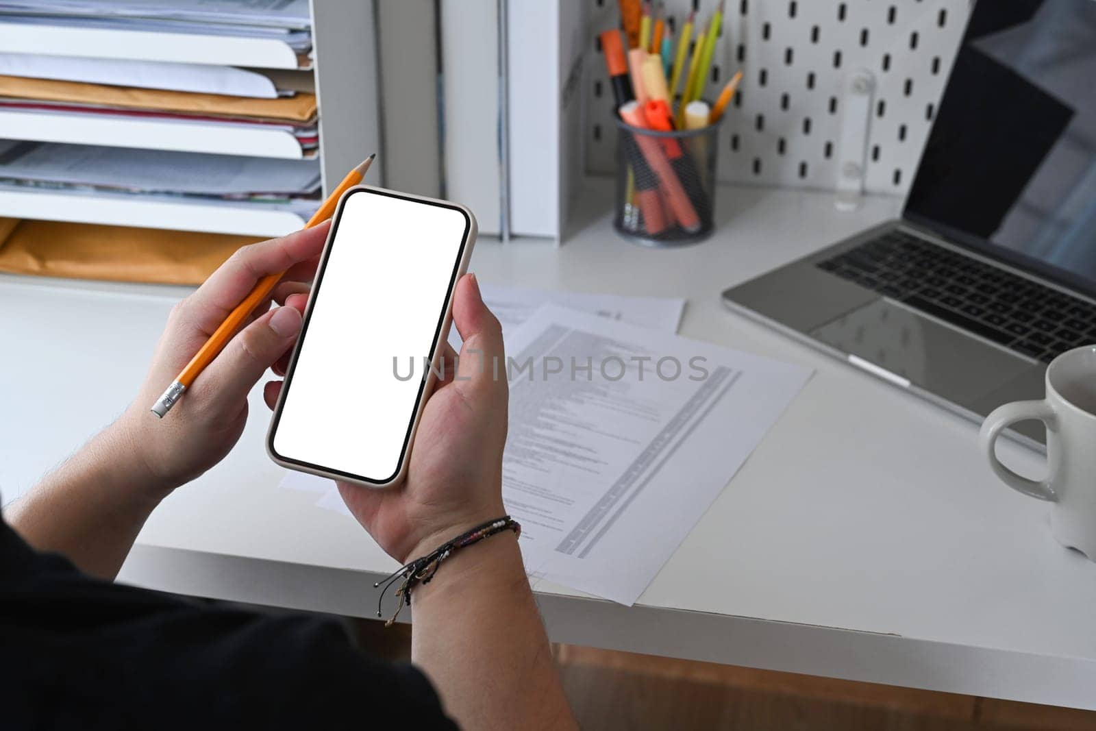 Man hand holding mobile phone with empty screen for advertise text.