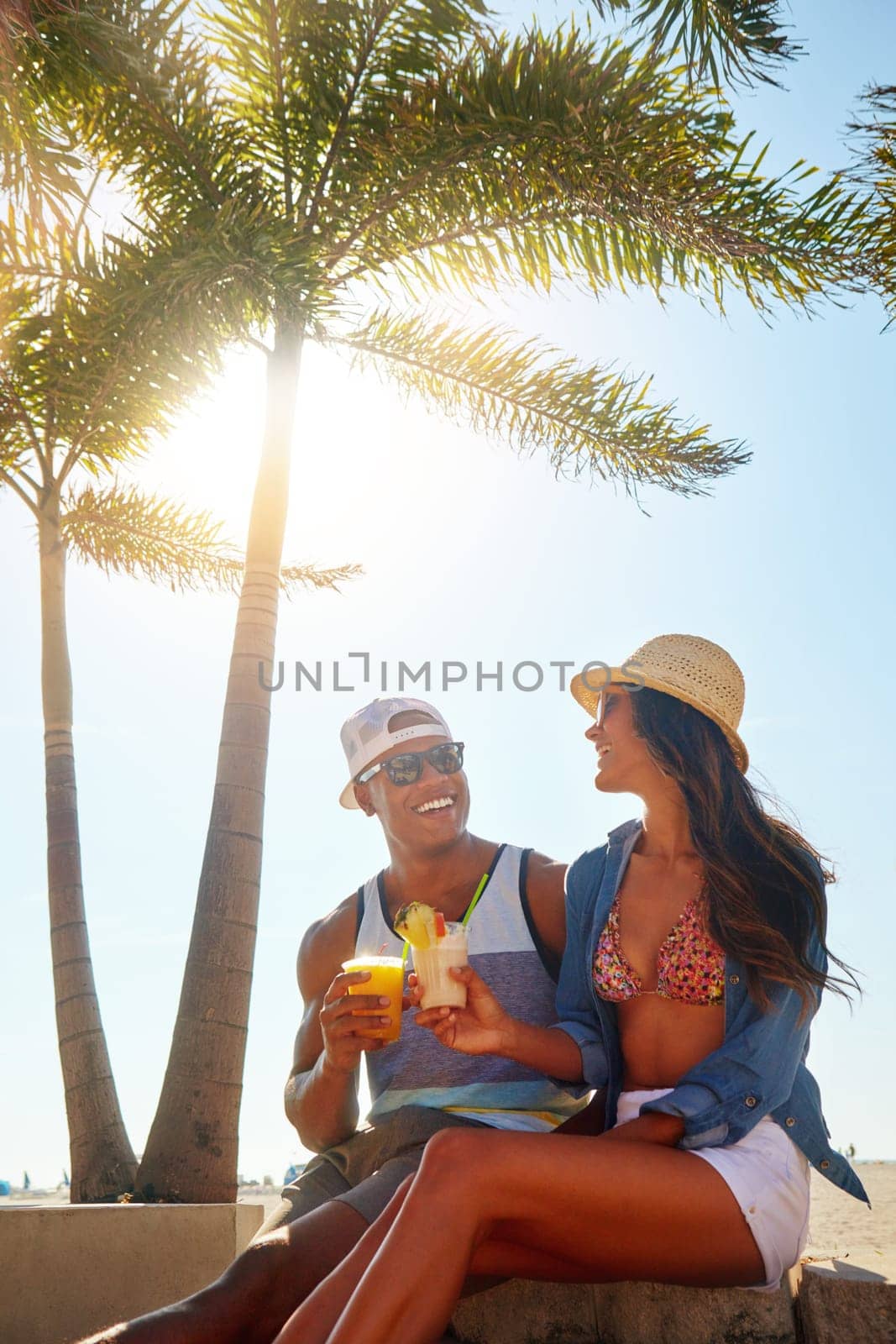 Carefree summer days. an affectionate young couple spending a summers day outdoors. by YuriArcurs