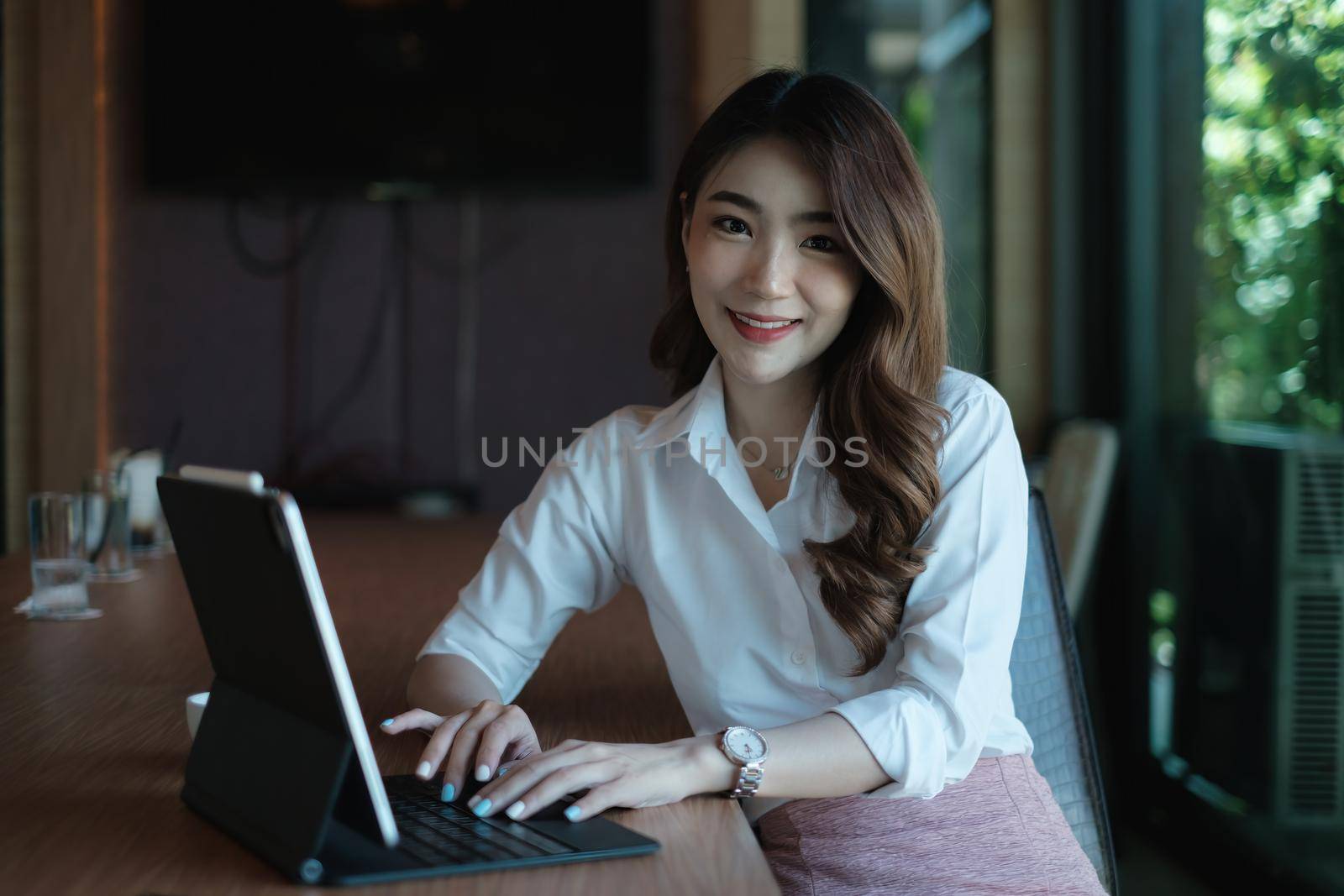 Business woman speaking on video call on online briefing with laptop computer at her office.