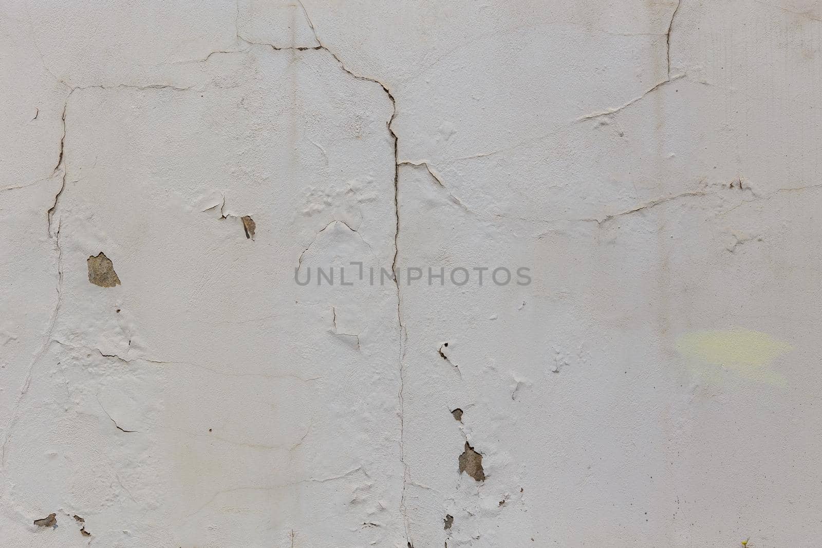 shabby dry white plaster under direct sunlight texture and full frame background