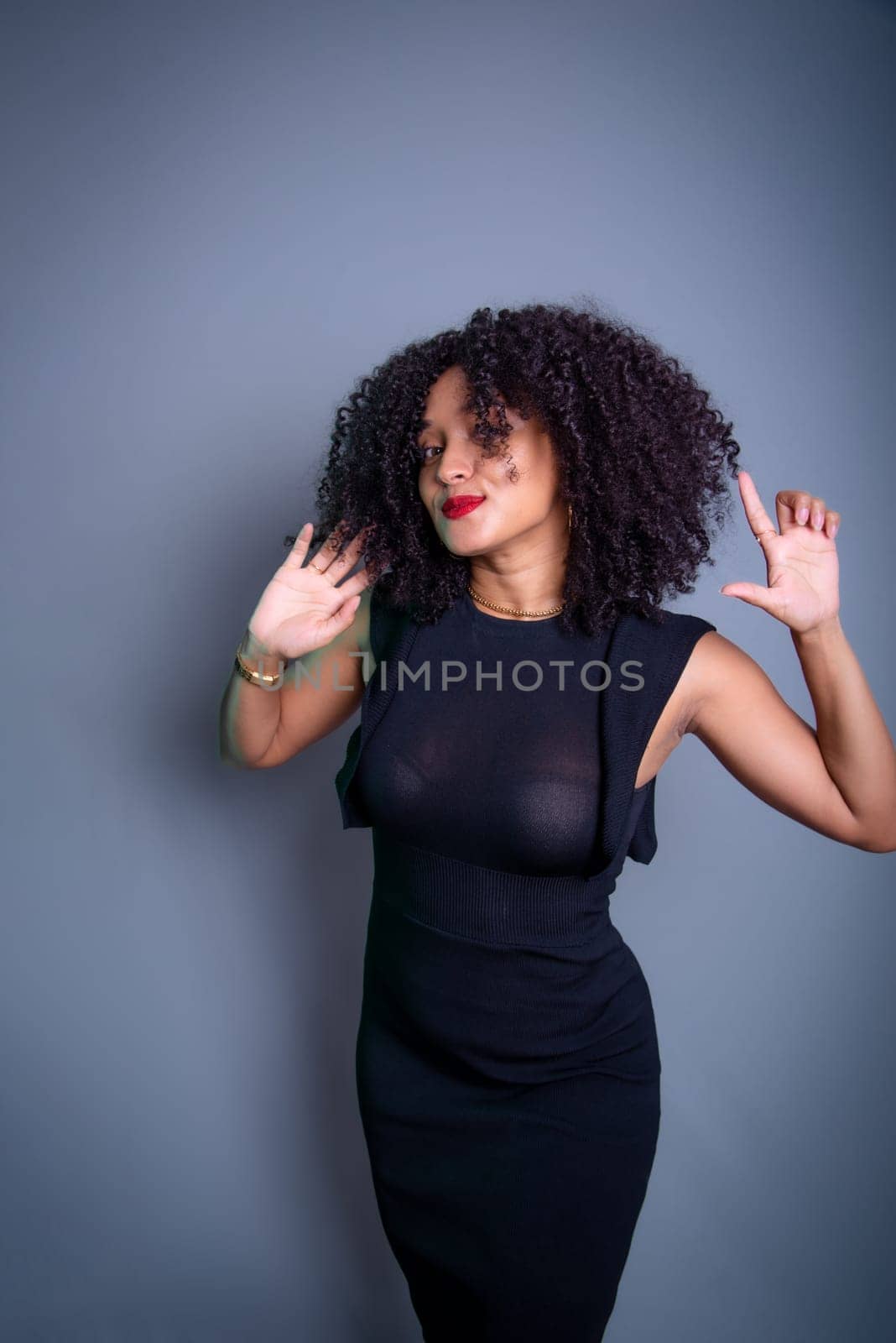 Beautiful young woman relaxed and happy against gray background. studio portrait