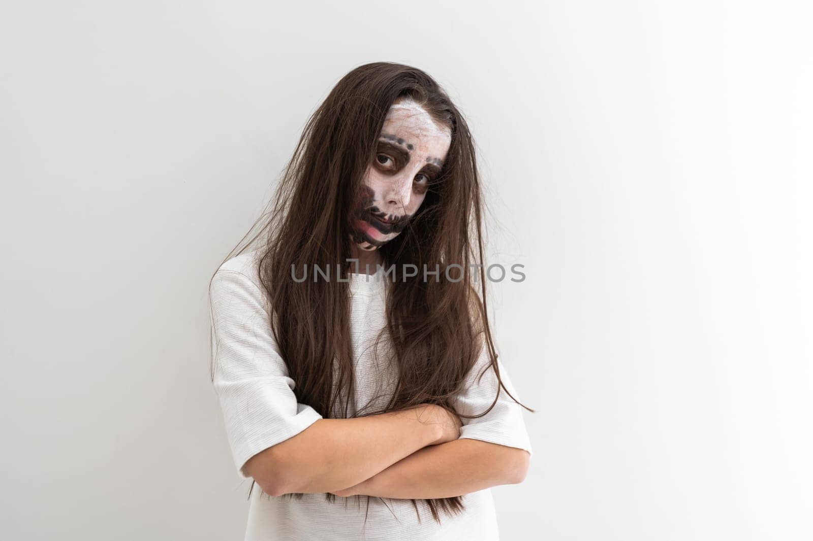 portrait of teenage girl with skull makeup on face