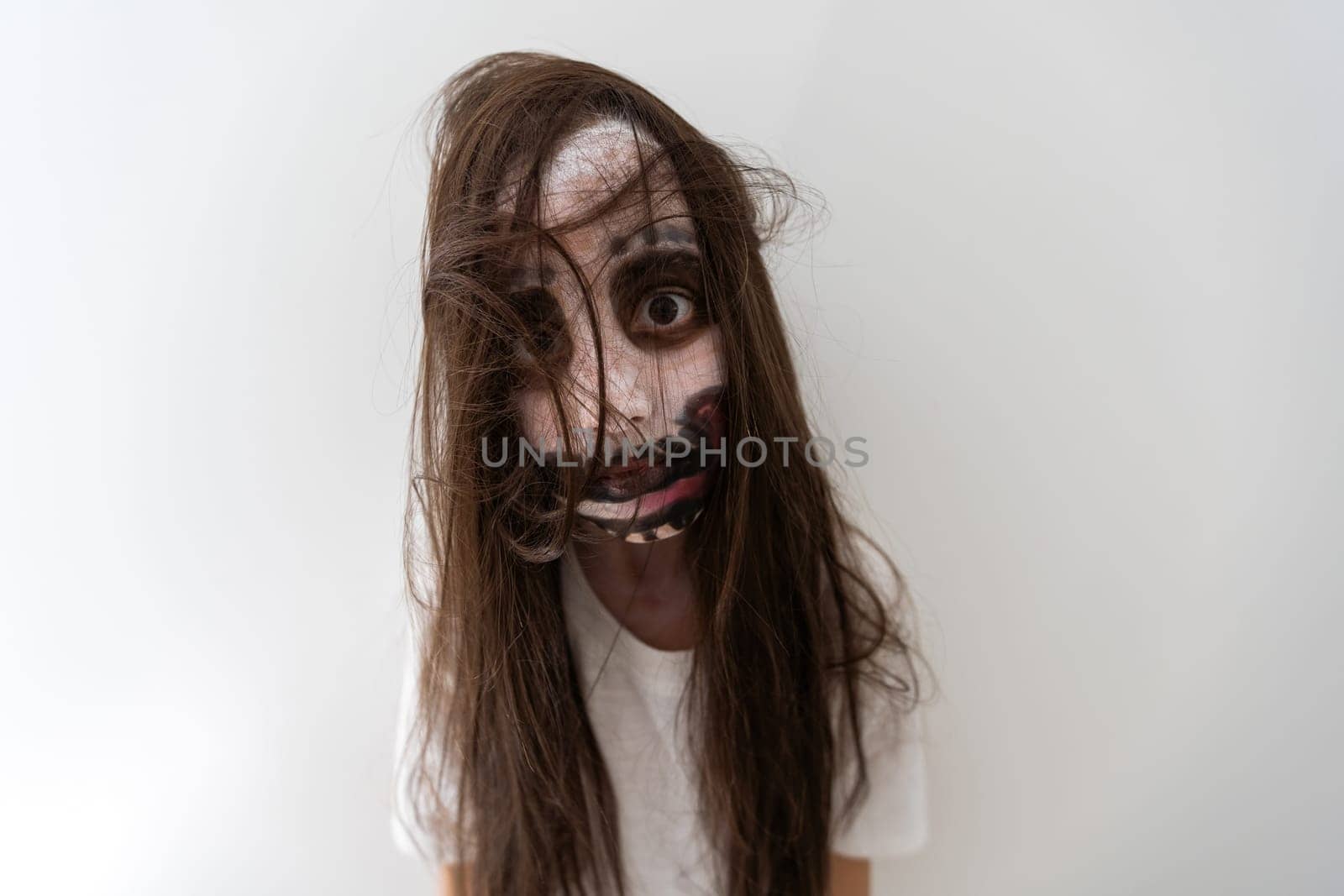 portrait of teenage girl with skull makeup on face