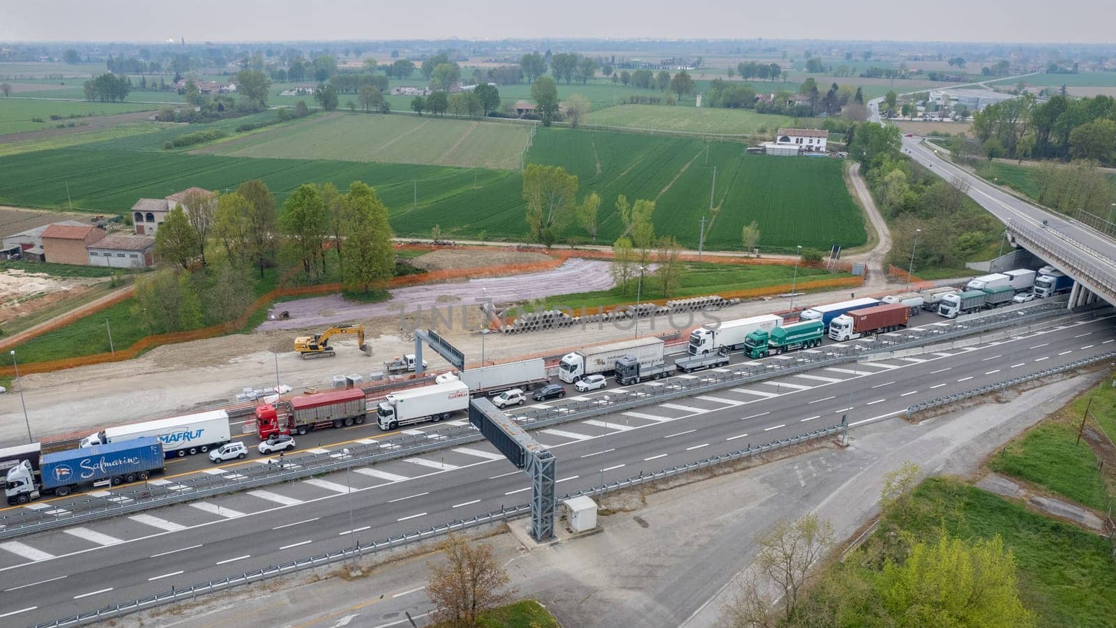 Motorway traffic jam transport cargo trucks and cars stop wait by verbano