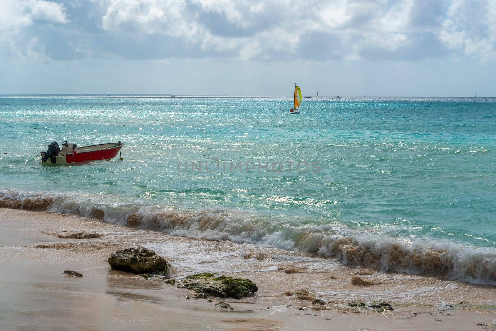 Boat with a sail in the warm waters of the Atlantic Ocean by ben44