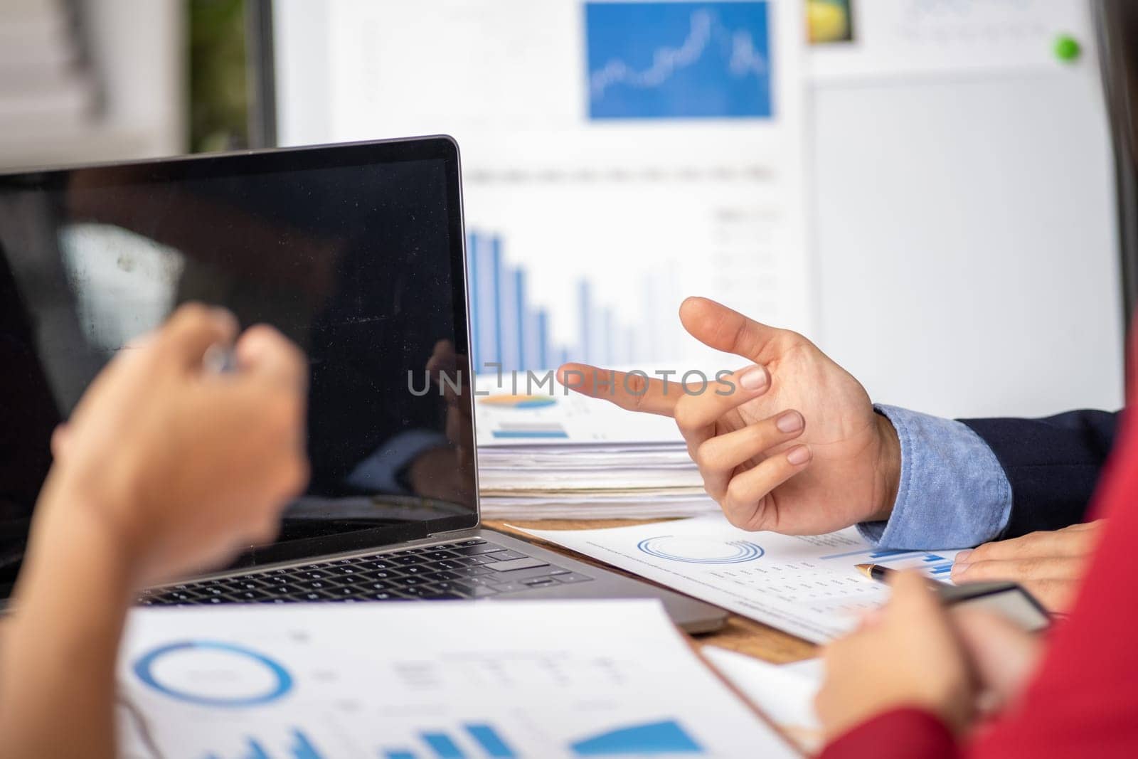 Closed up office conference room meeting diverse team of top manager, successful happy business team discussion share idea talking together, Young business group up meeting and pointing to the paper document report figure. High quality photo