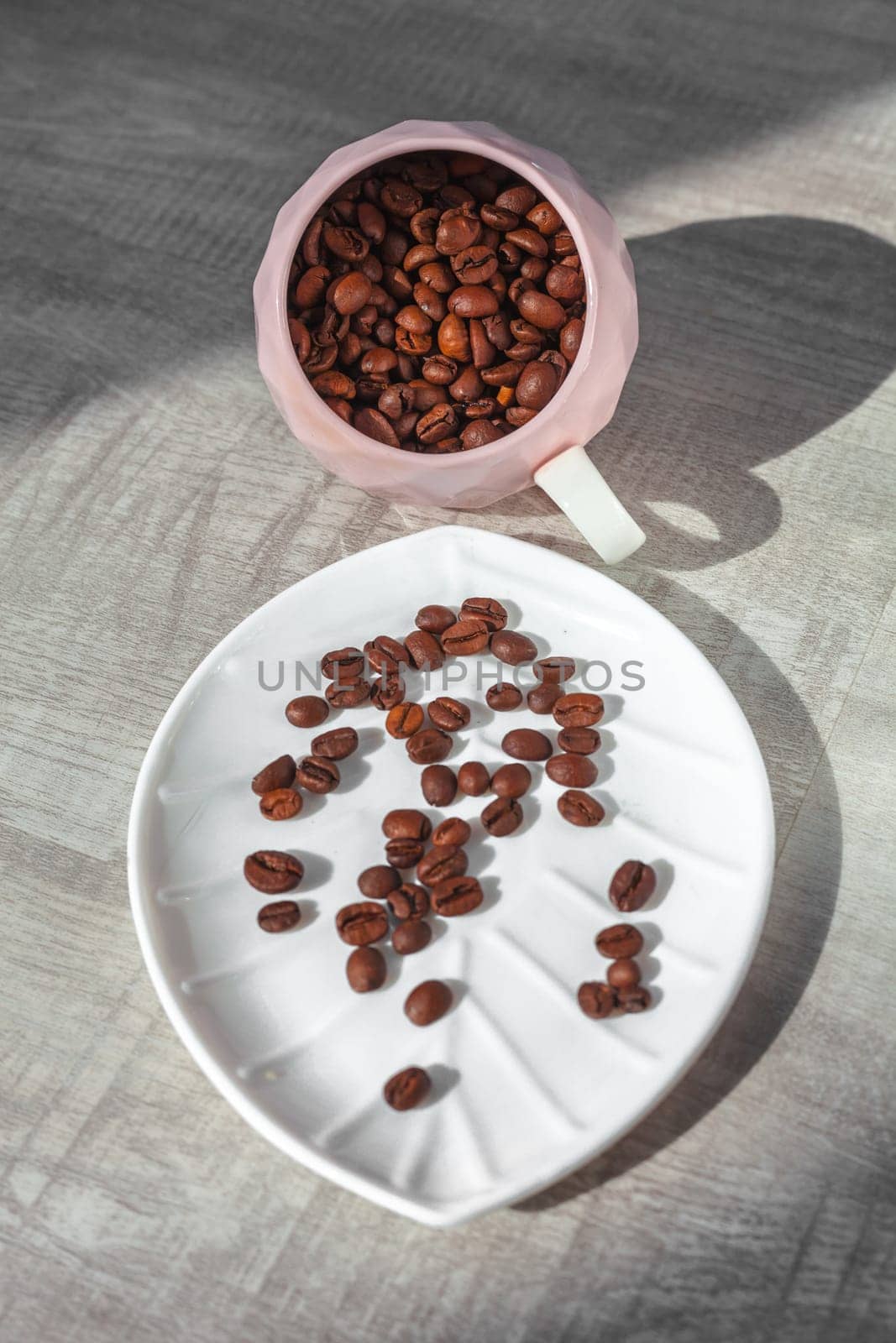 coffee beans in cup fall on the plate