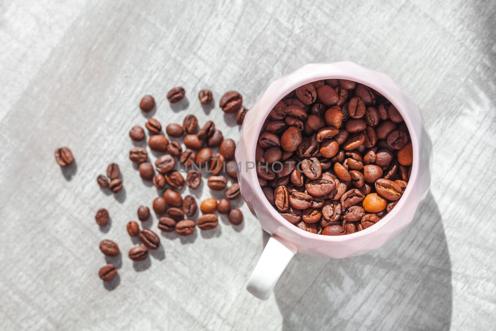 coffee beans in cup on the table and coffee beans around cup