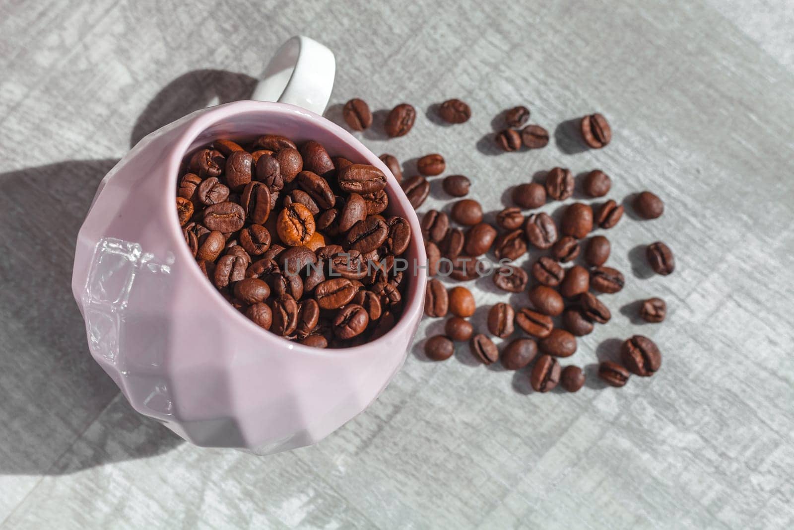 coffee beans in cup on the table and coffee beans around cup