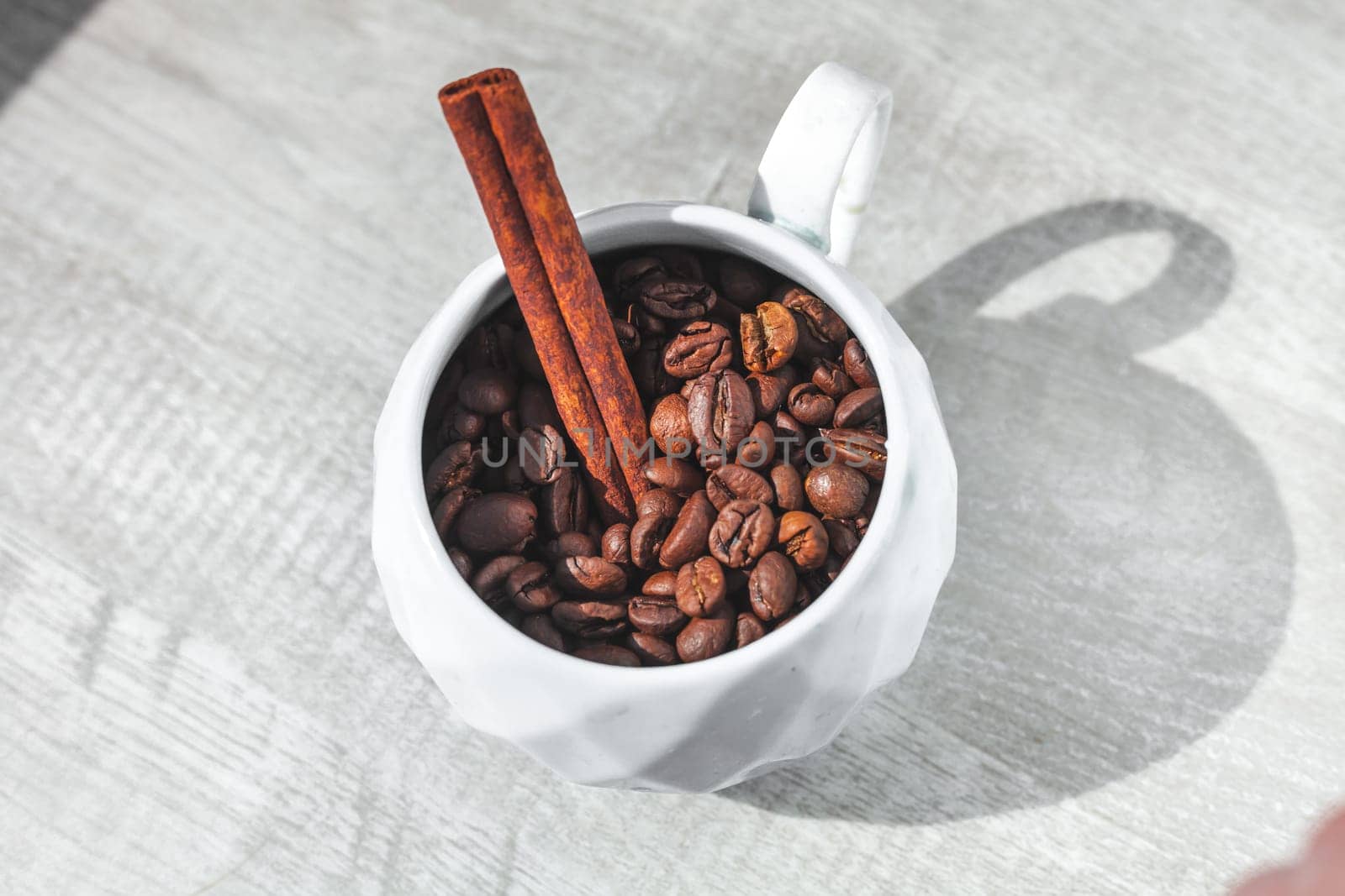 cinnamon in cup of coffee beans on the table