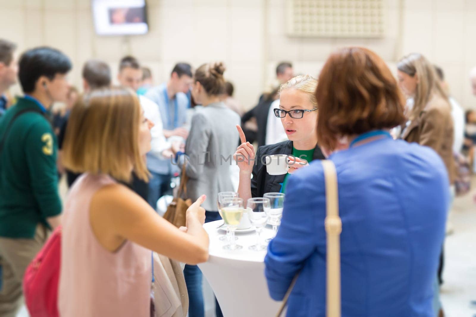 People interacting during coffee break at medical or scientific conference. by kasto