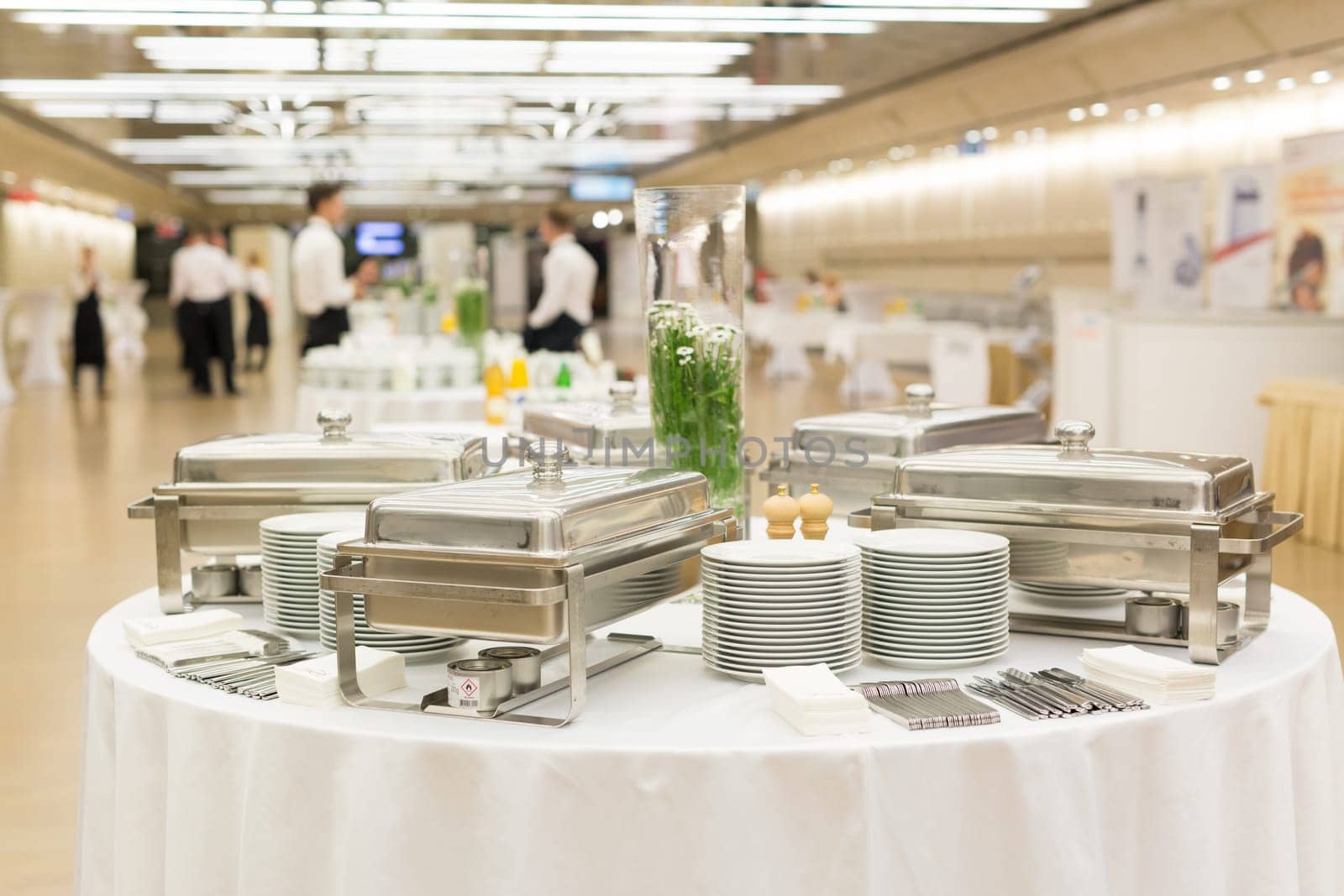 Waiters prepare buffet before a coffee break at business conference meeting. by kasto