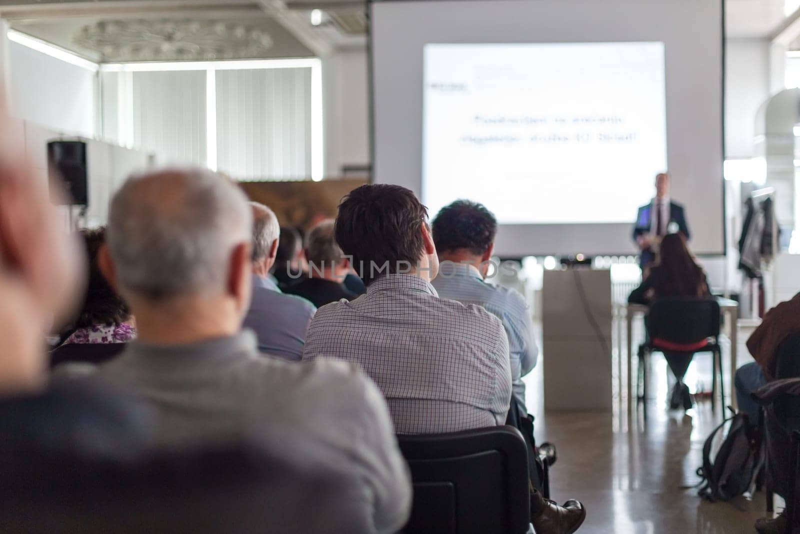 Business speaker giving a talk at business conference event. by kasto