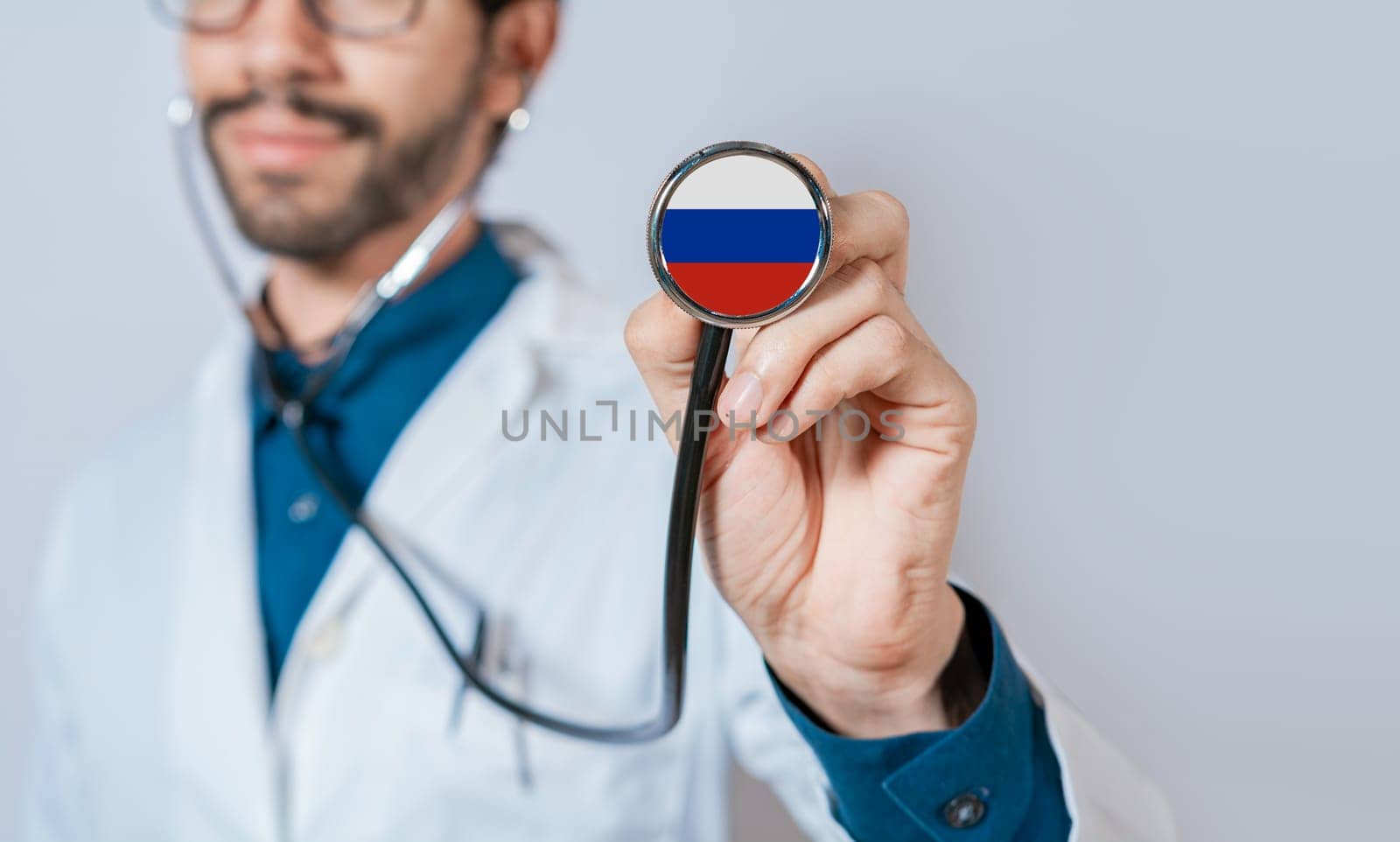 Russia flag on stethoscope. Doctor holding stethoscope with flag of Russia. Doctor showing stethoscope with flag of Russian Federation by isaiphoto