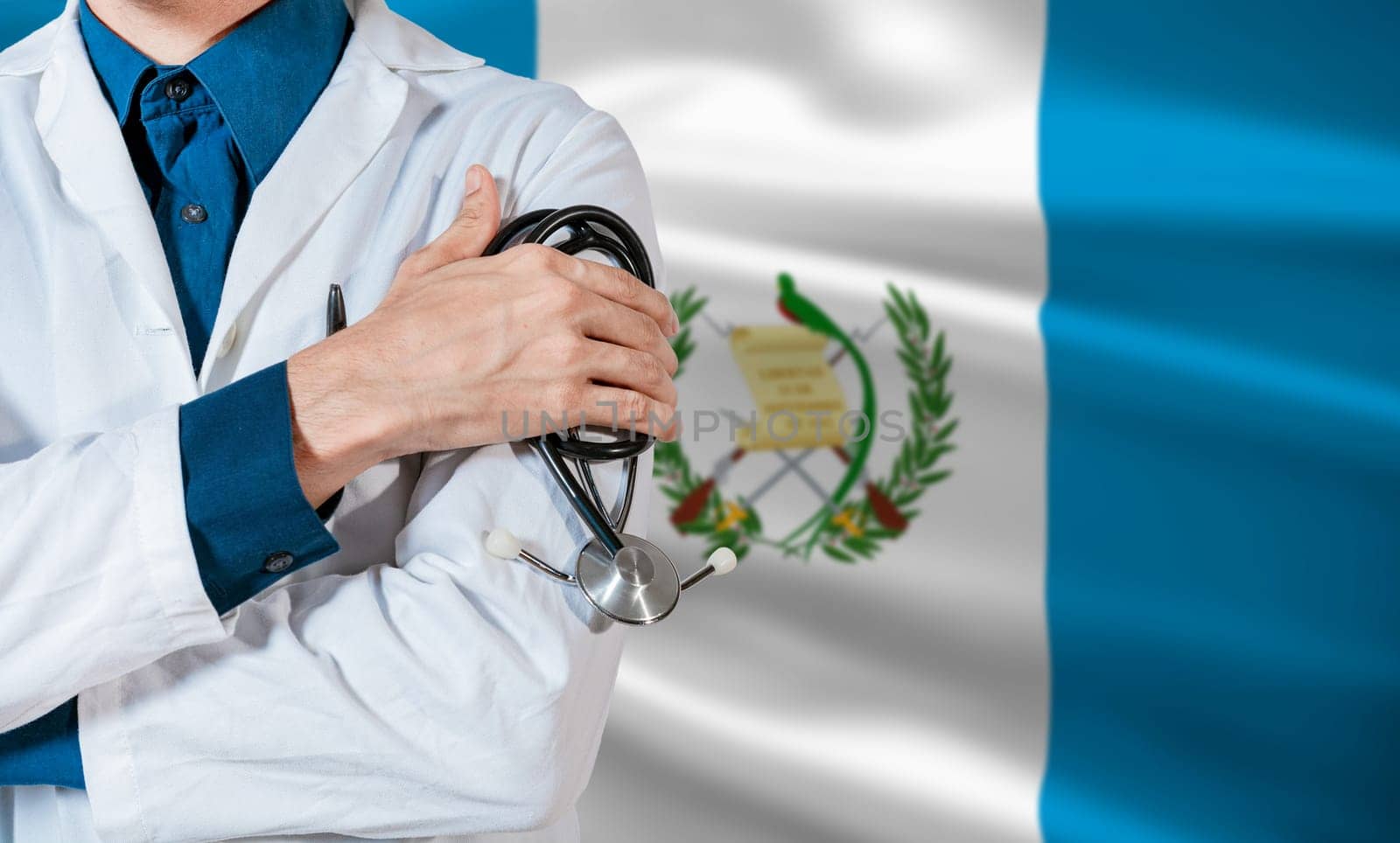 Doctor with stethoscope on guatemala flag. Health and care with the flag of Guatemala. Guatemala national health concept, Doctor arm with stethoscope on Guatemala flag