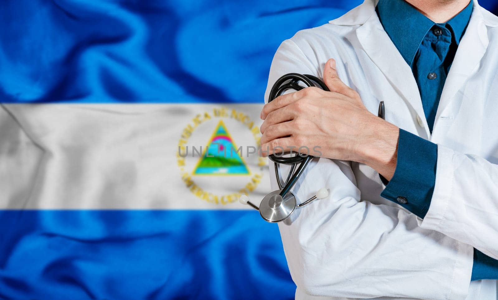 Health and care with the flag of Nicaragua. Nicaragua national health concept, Doctor arm holding stethoscope on nicaragua flag. Doctor with stethoscope on Nicaragua flag